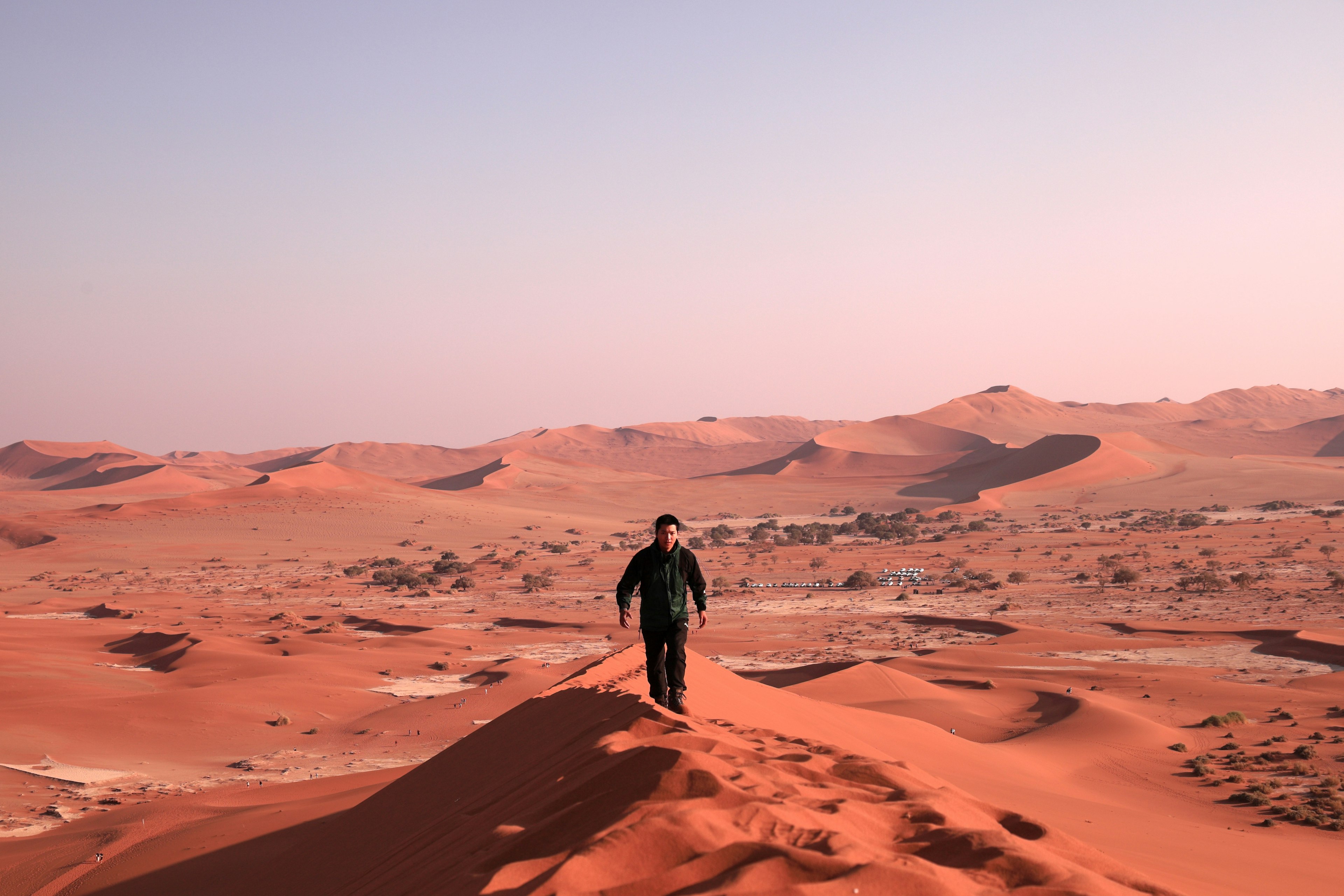 Person walking on red sand dunes