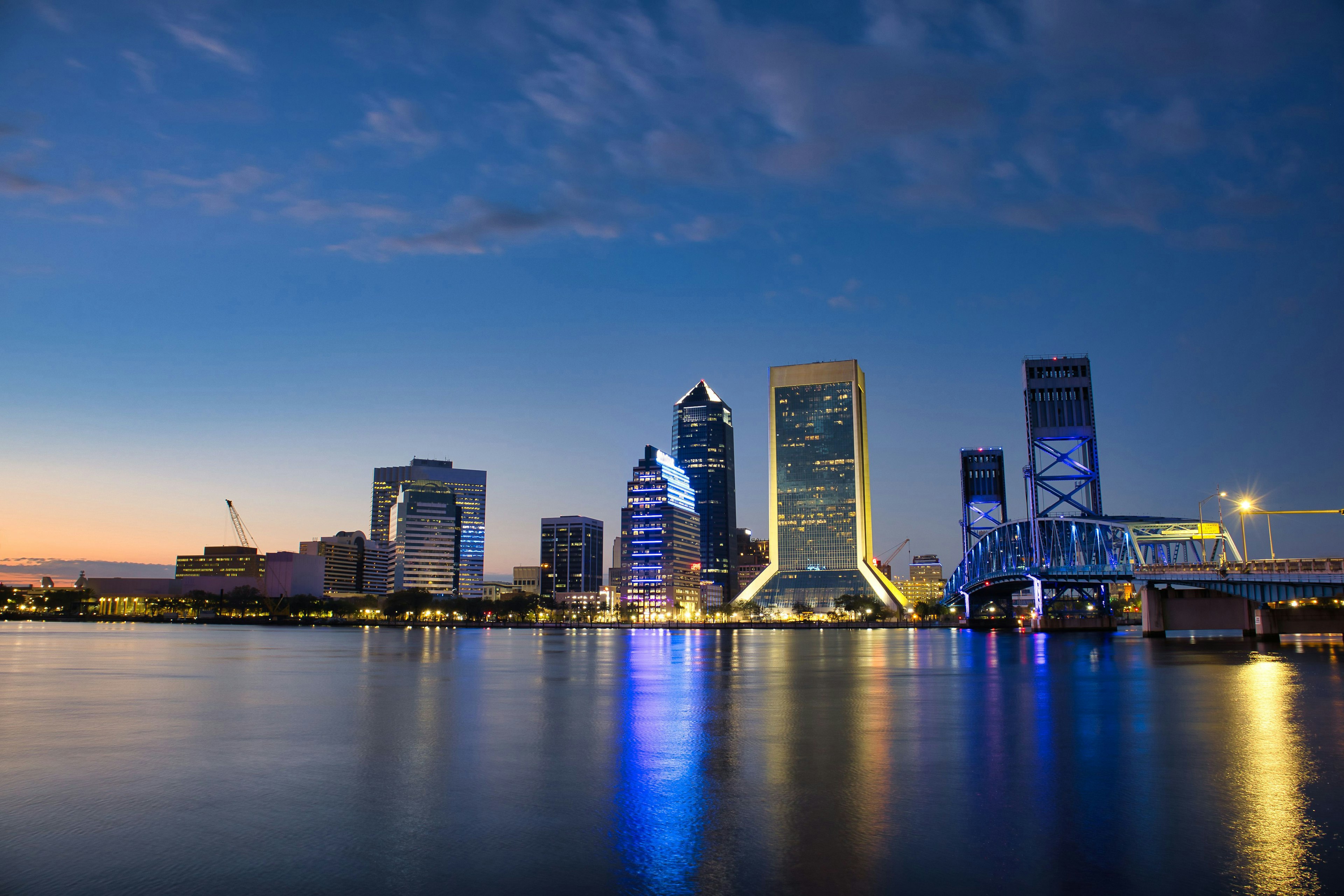 Jacksonville skyline at dusk reflecting on the water