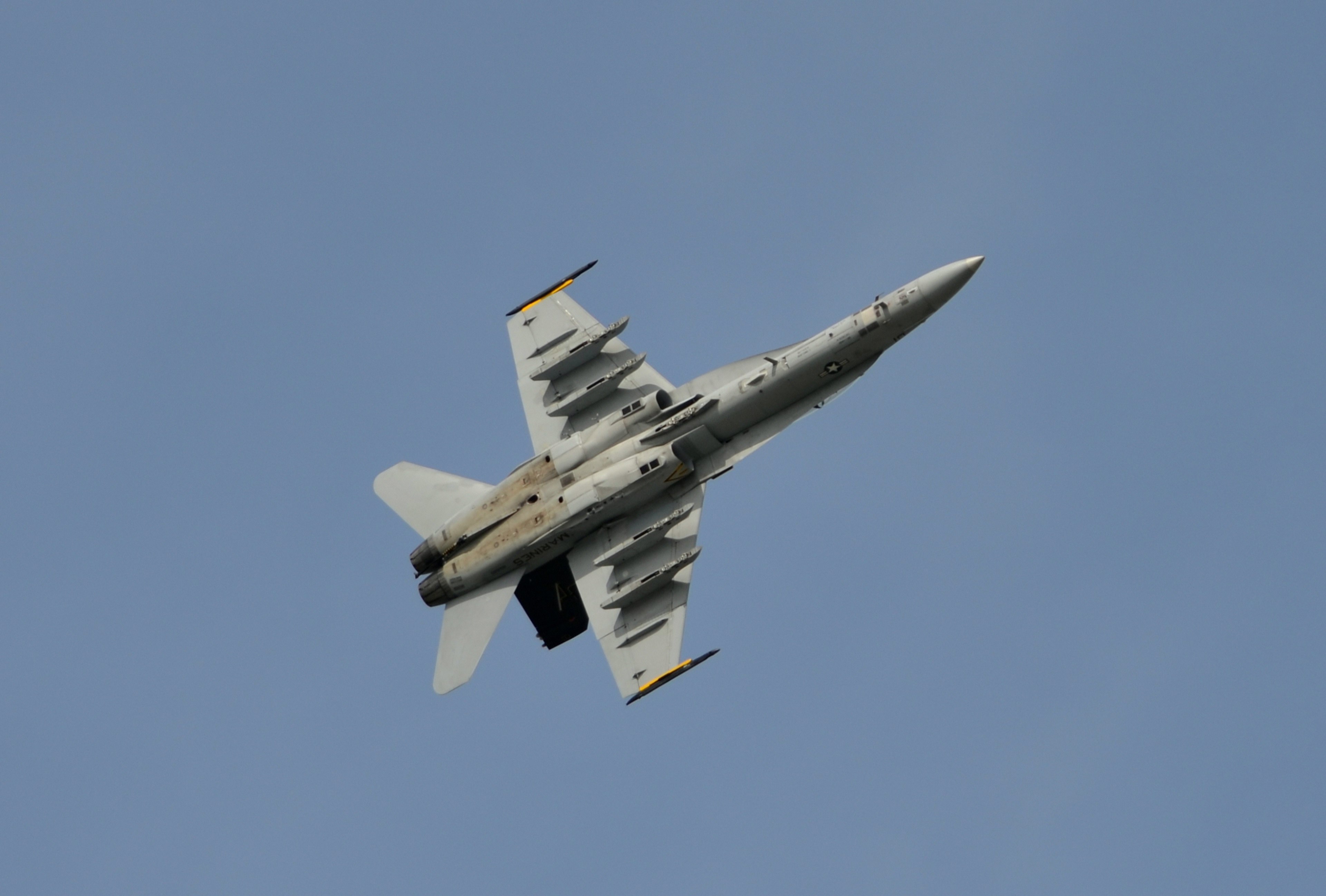 F/A-18 fighter jet flying upside down in the sky