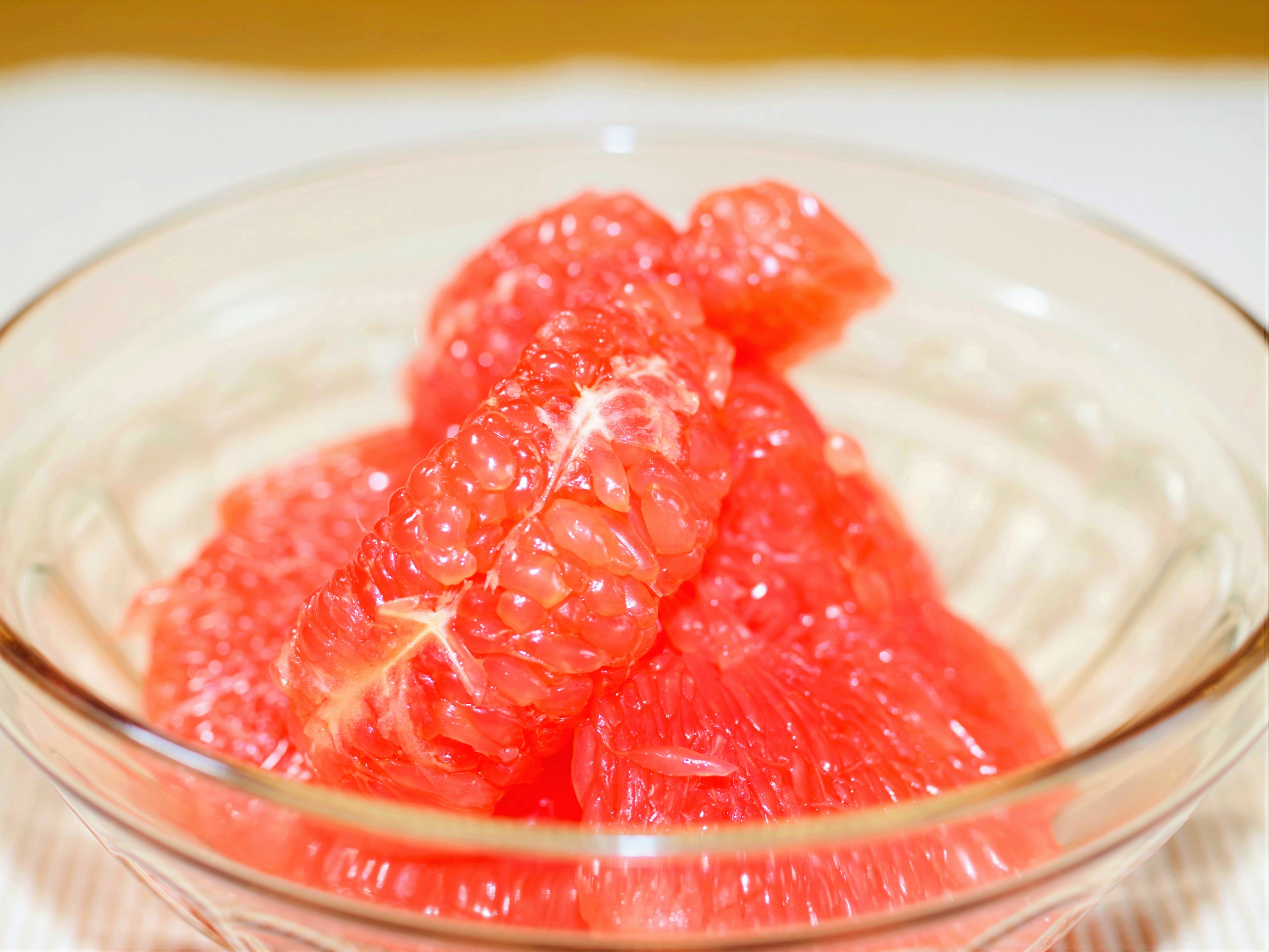 Fresh grapefruit segments piled in a clear bowl