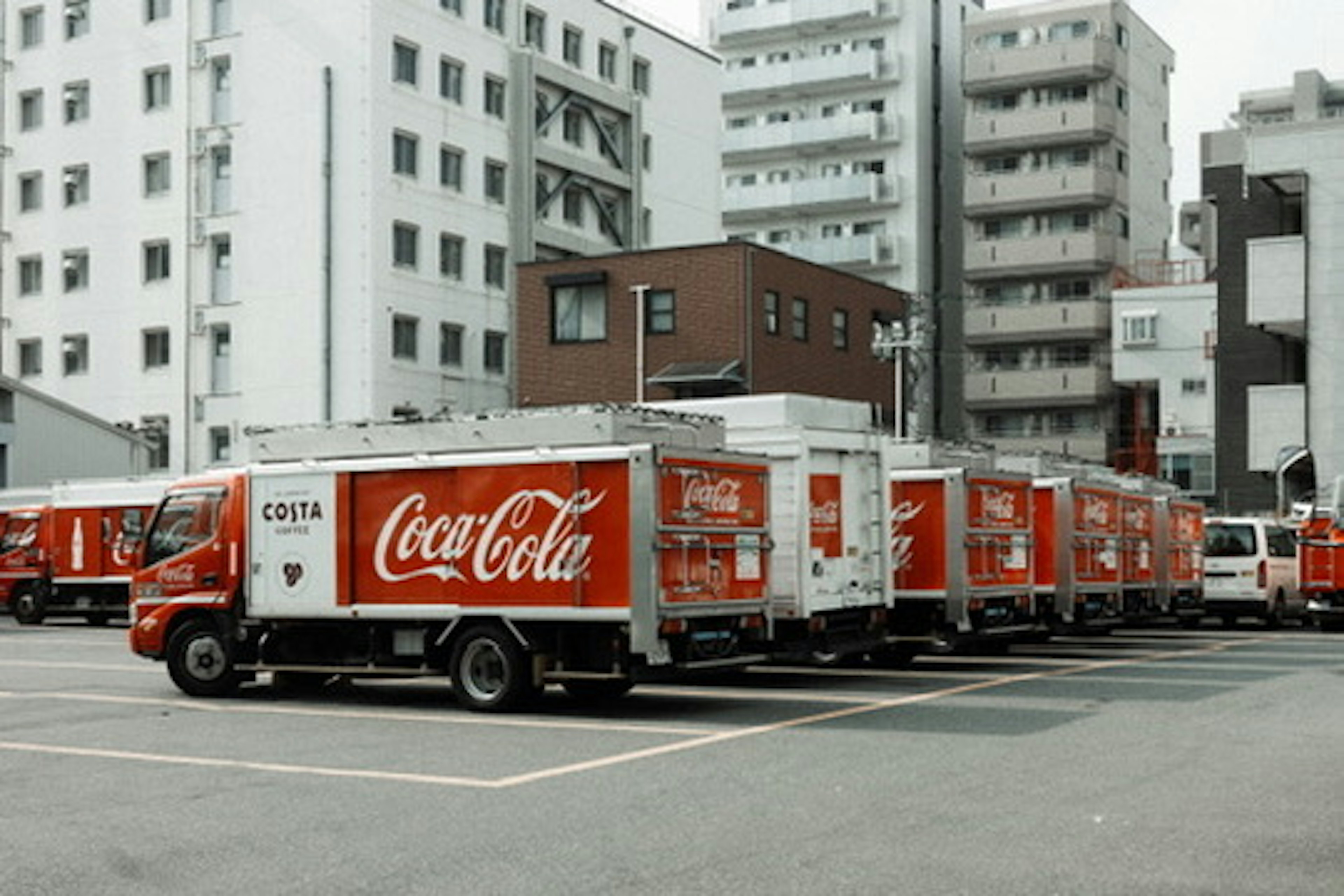 Coca-Cola trucks parked in an urban setting