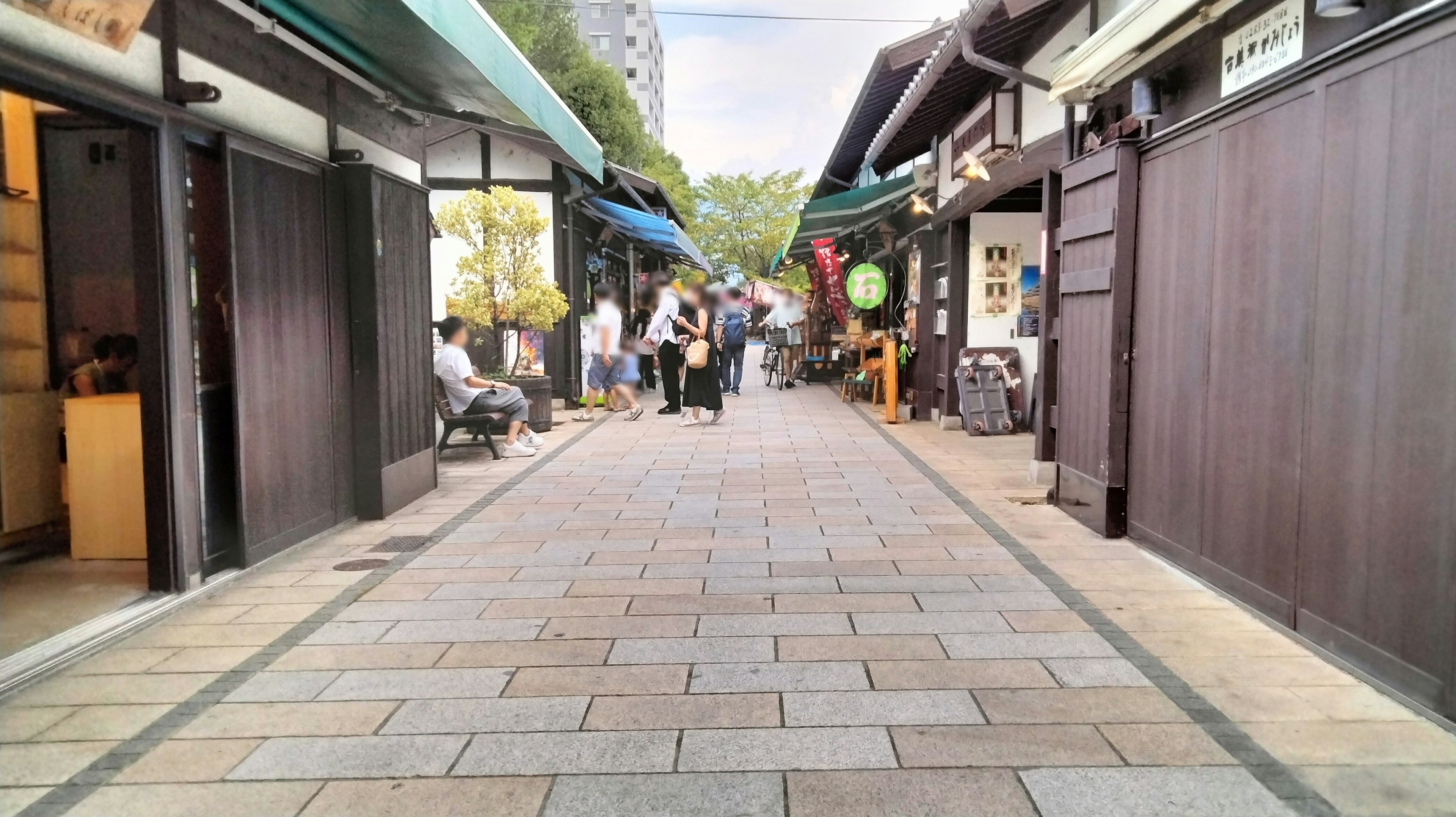 A quiet street lined with traditional buildings and visitors