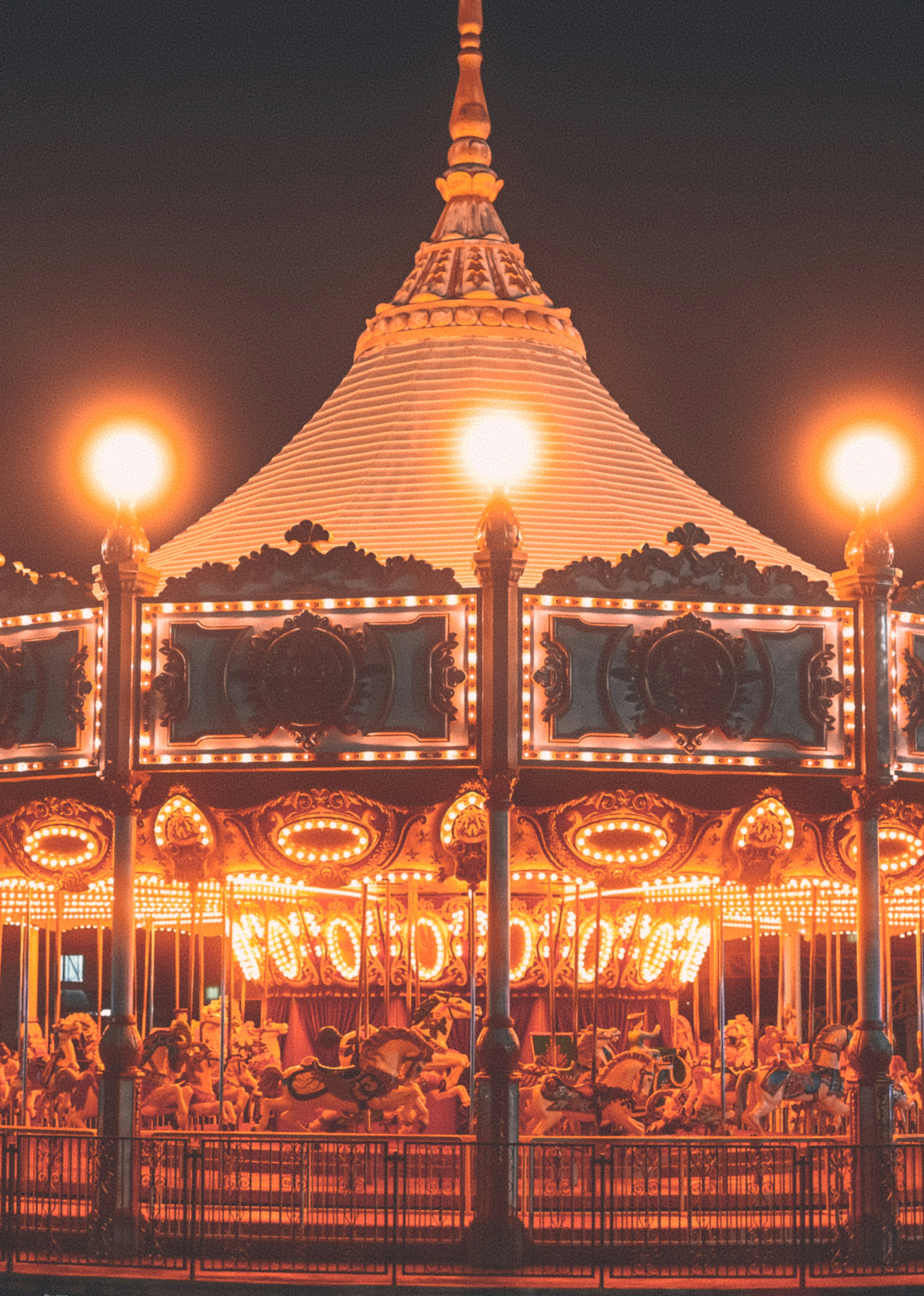 Nighttime carousel with bright lights and decorative design