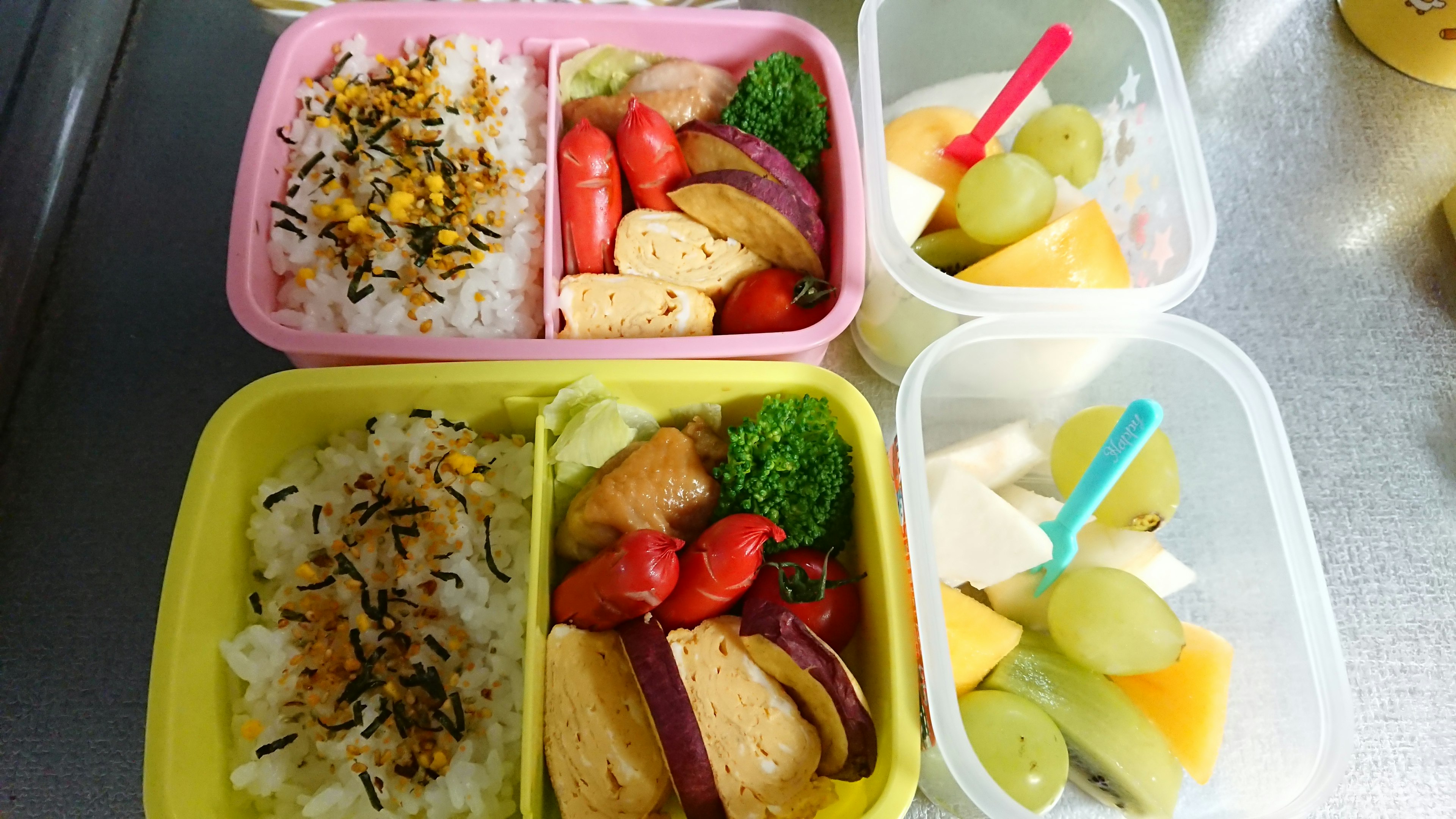 Colorful bento boxes filled with rice and various side dishes