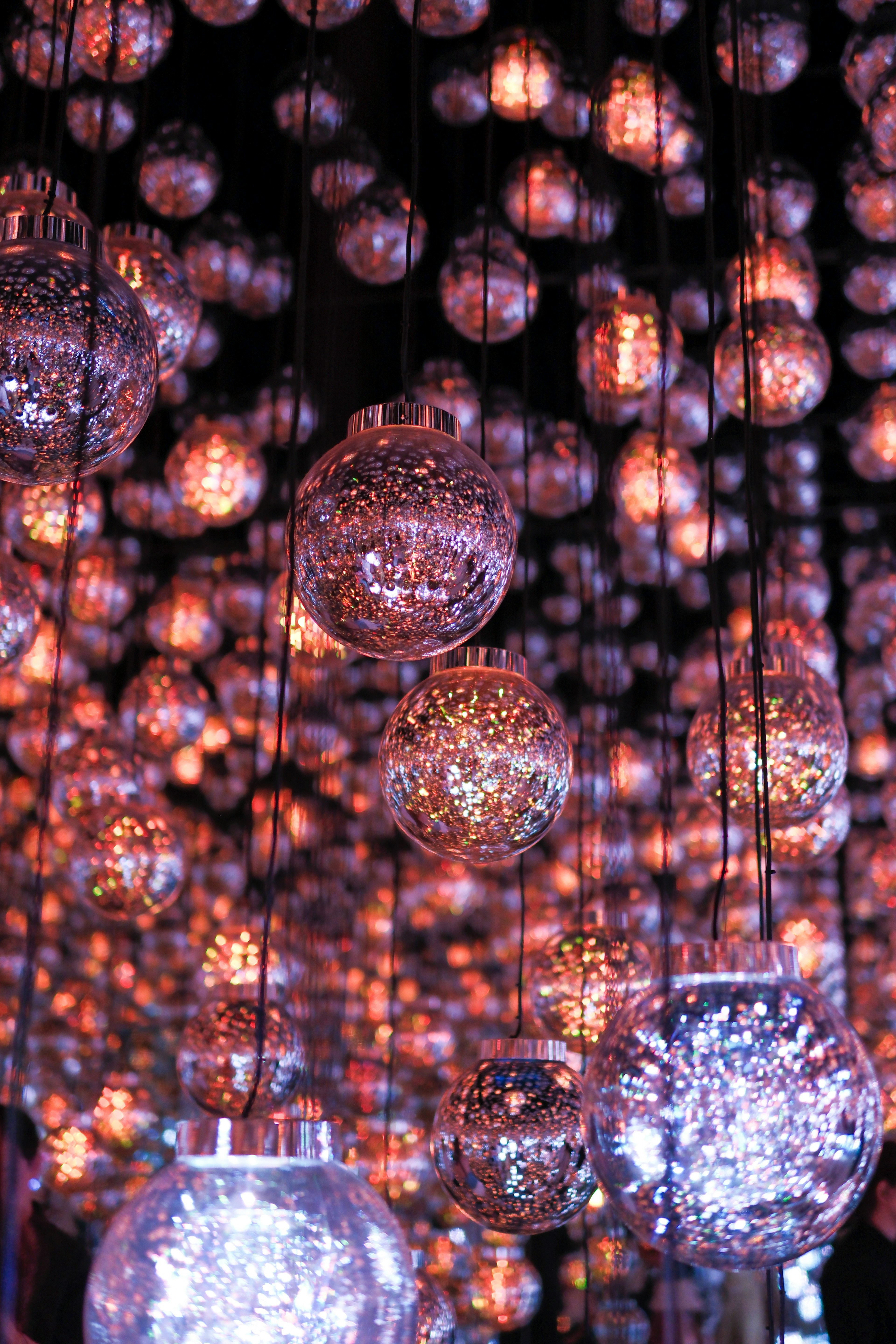 A mesmerizing display of hanging decorative spheres illuminated with soft lights