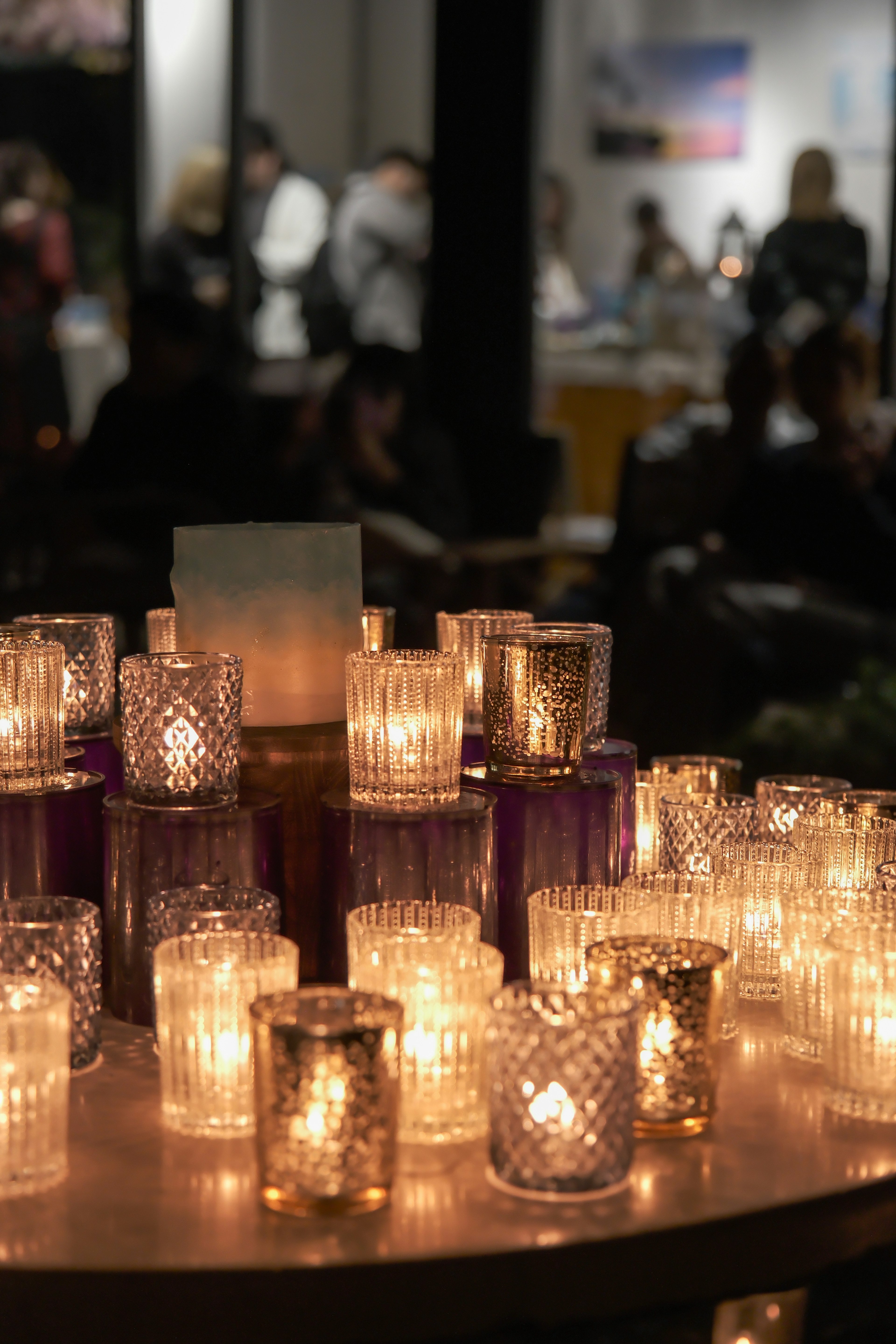 A collection of decorative candle holders illuminated with soft candlelight