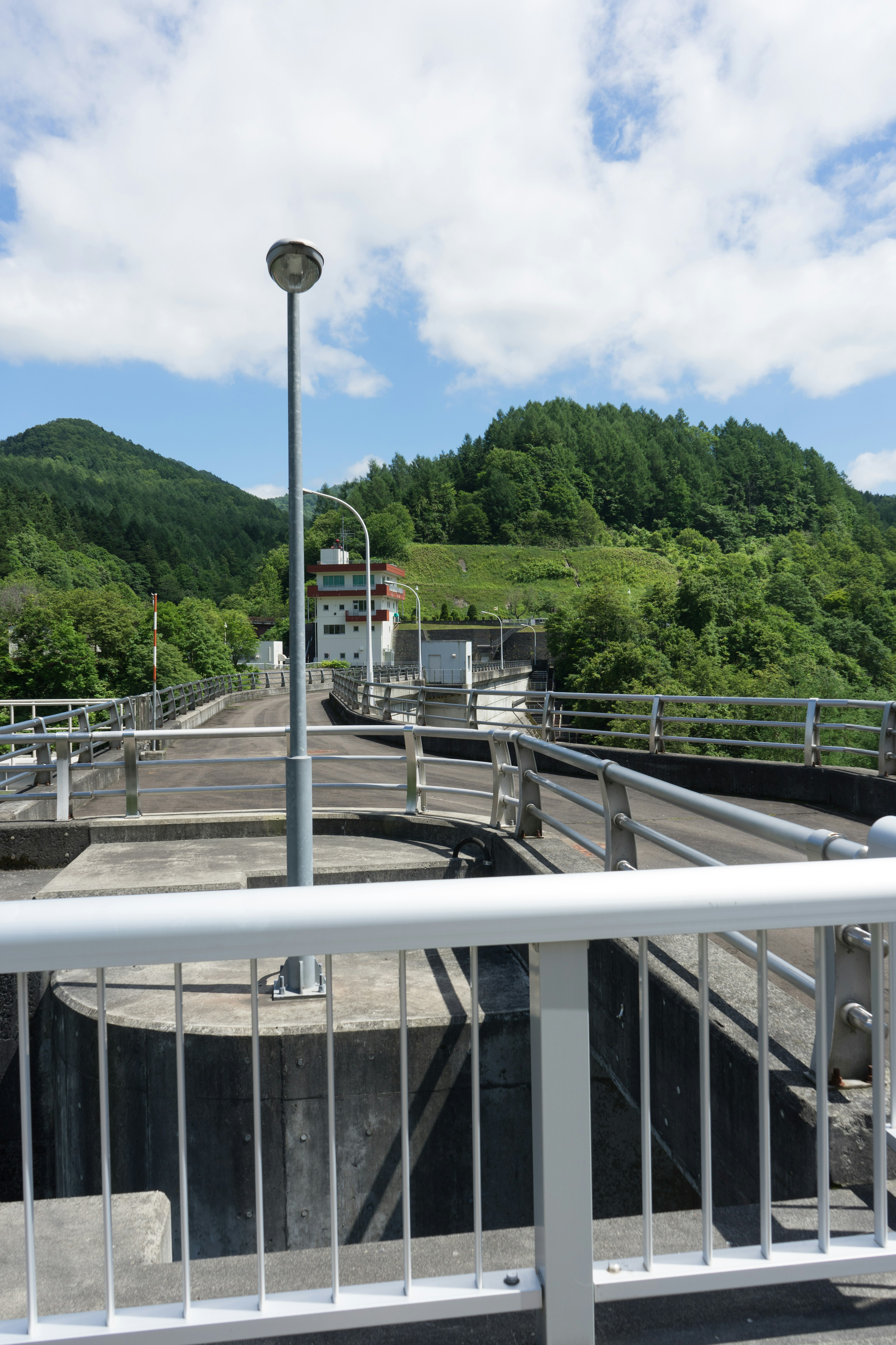 View of a water treatment facility with green hills in the background