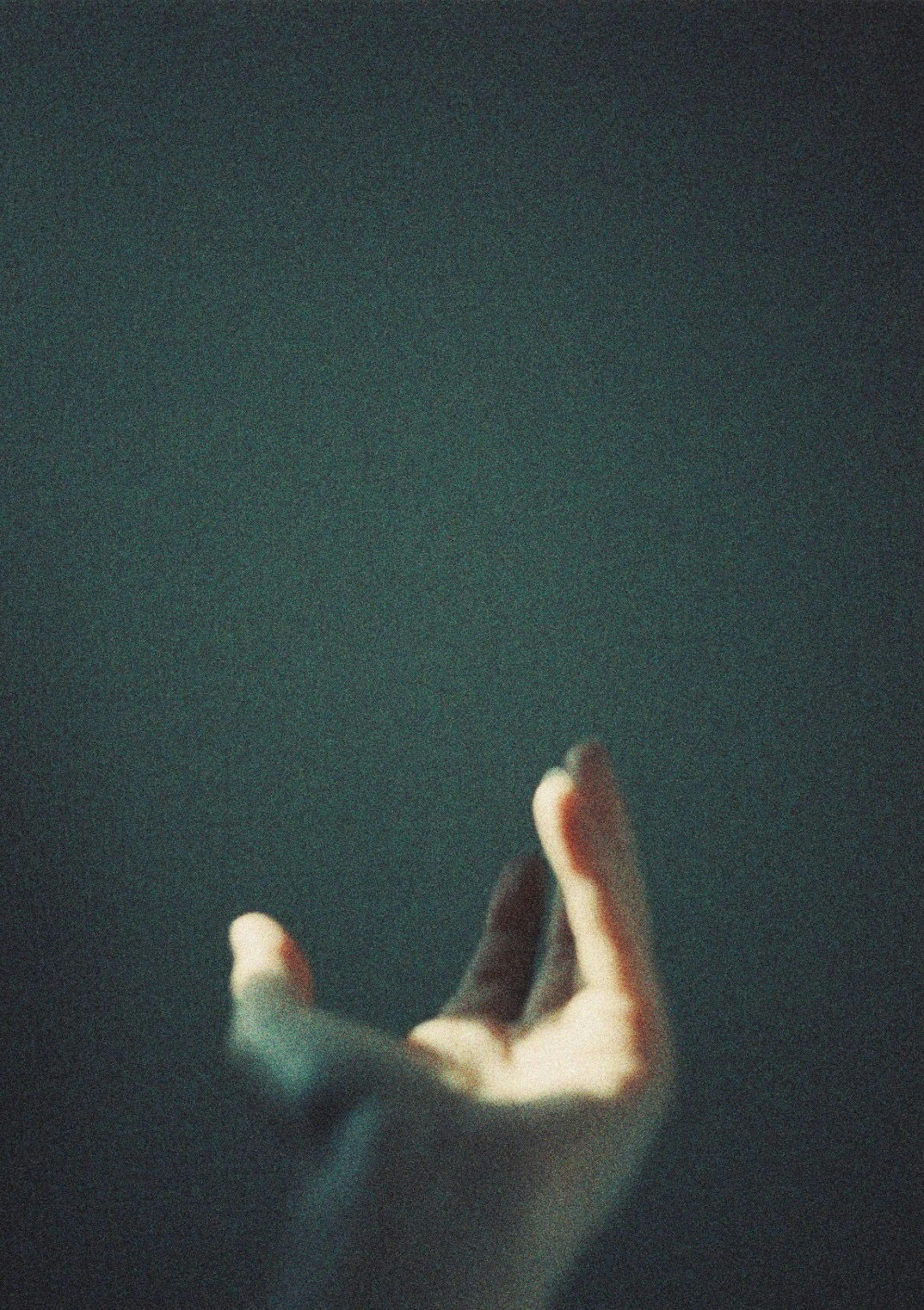 Image of an outstretched hand against a dark background