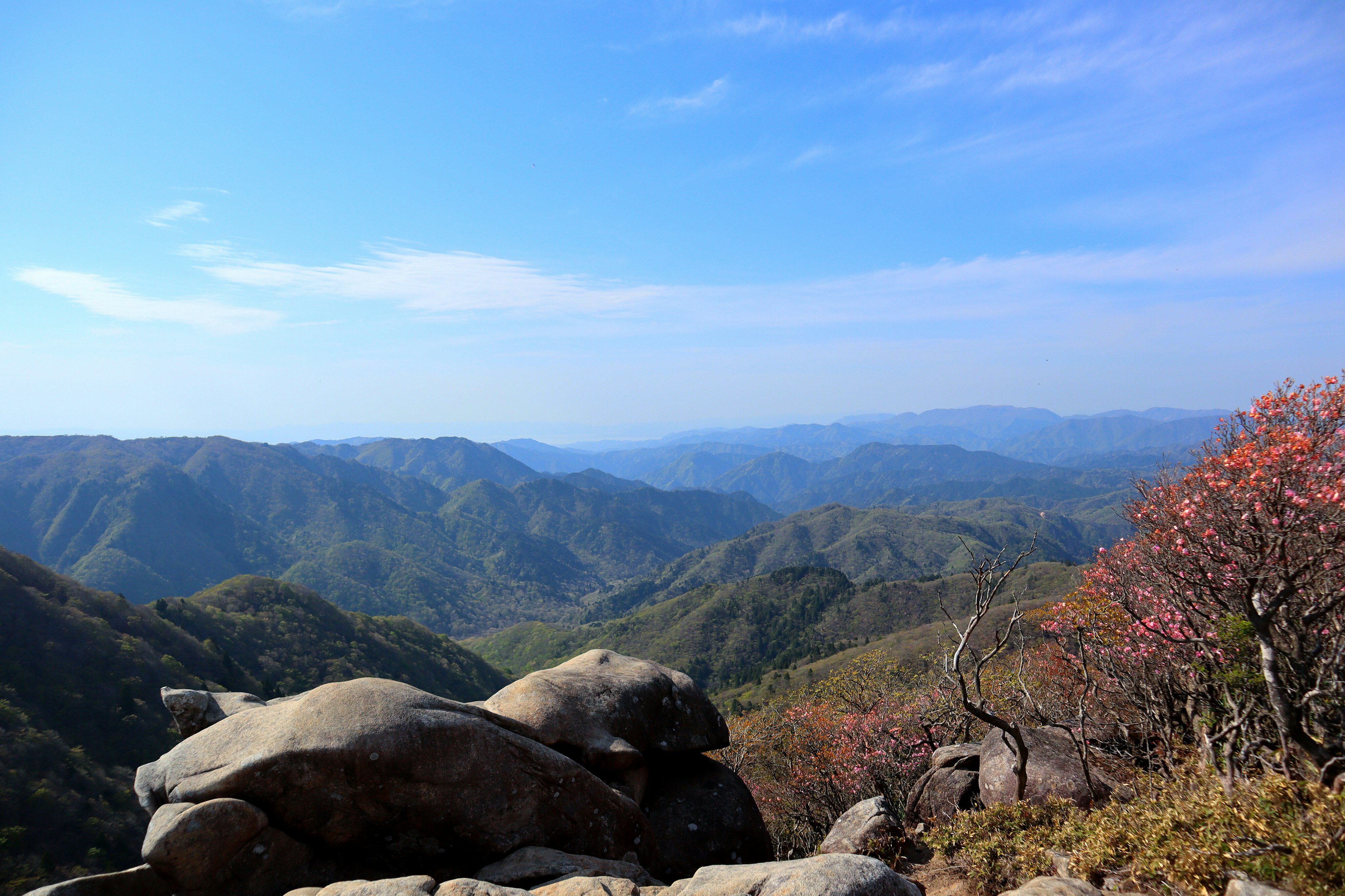 Beautiful landscape with blue sky and mountains large rocks and autumn foliage