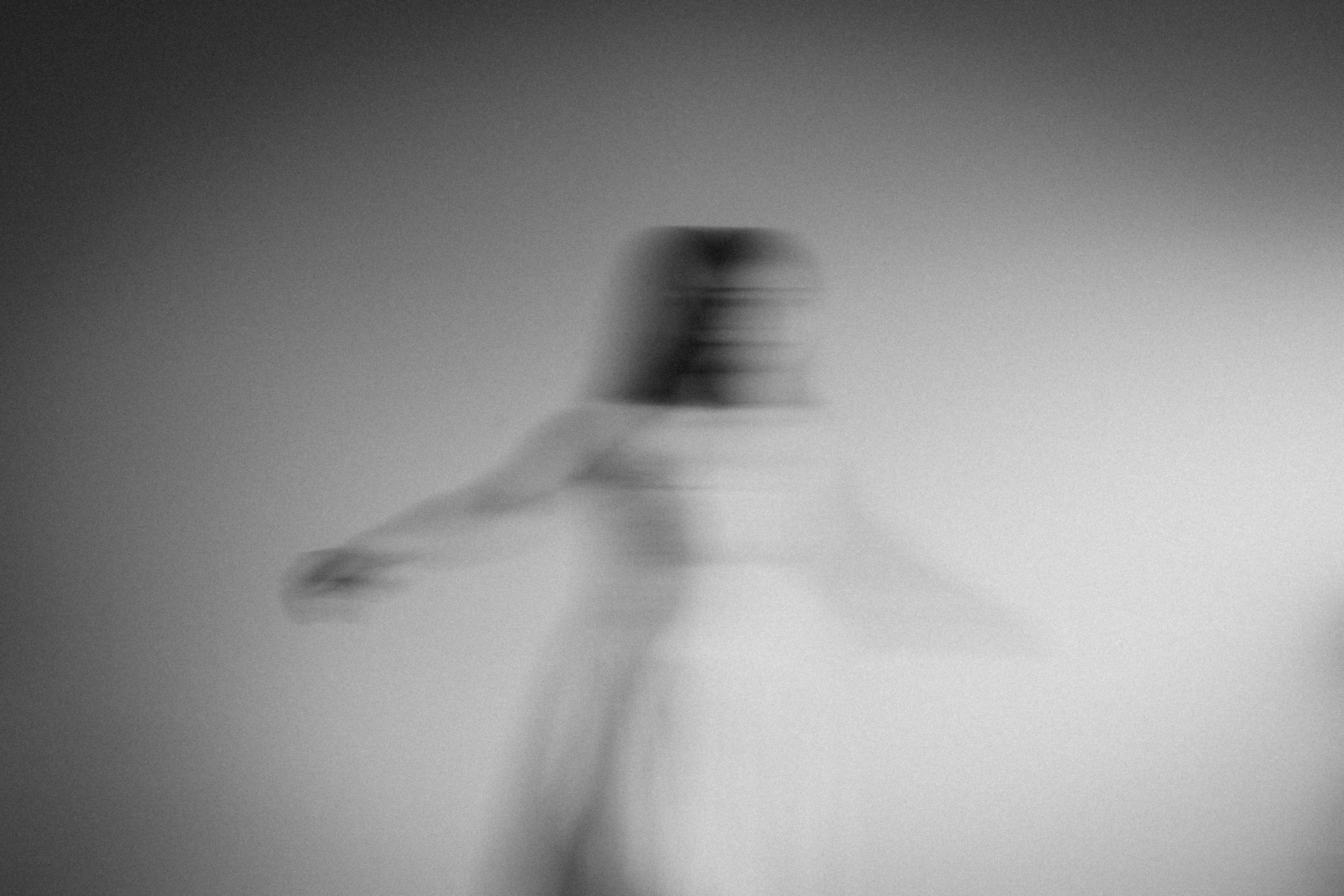 Blurred image of a girl in a white dress spinning