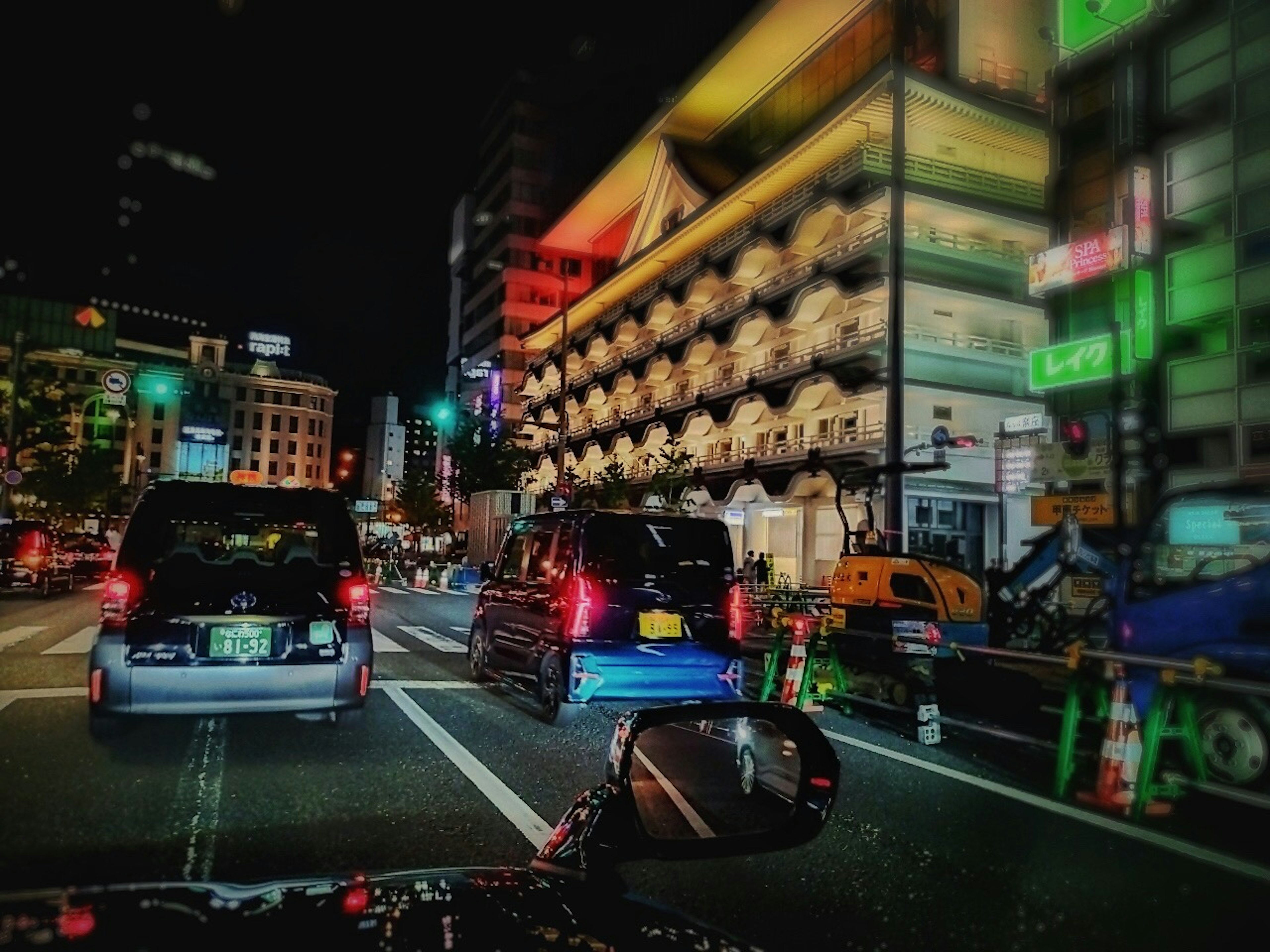 Nighttime city scene with flowing traffic and colorful billboards