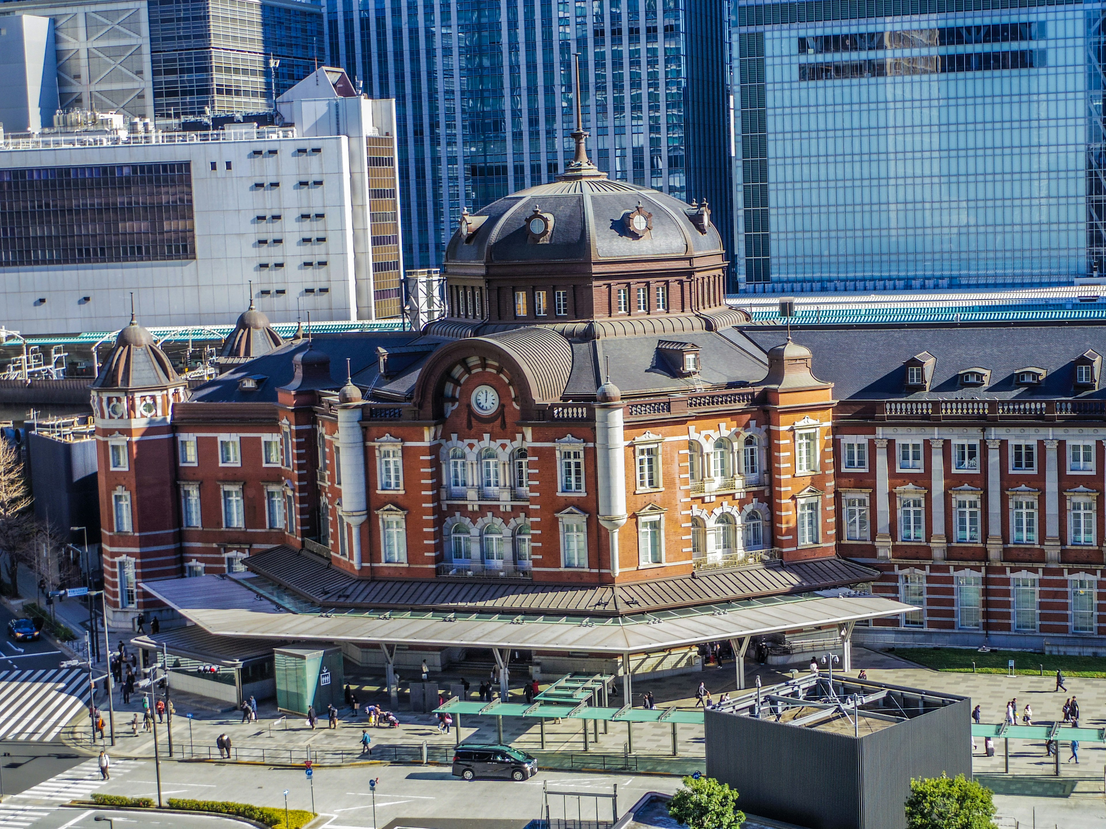 Historical Tokyo Station building surrounded by modern skyscrapers