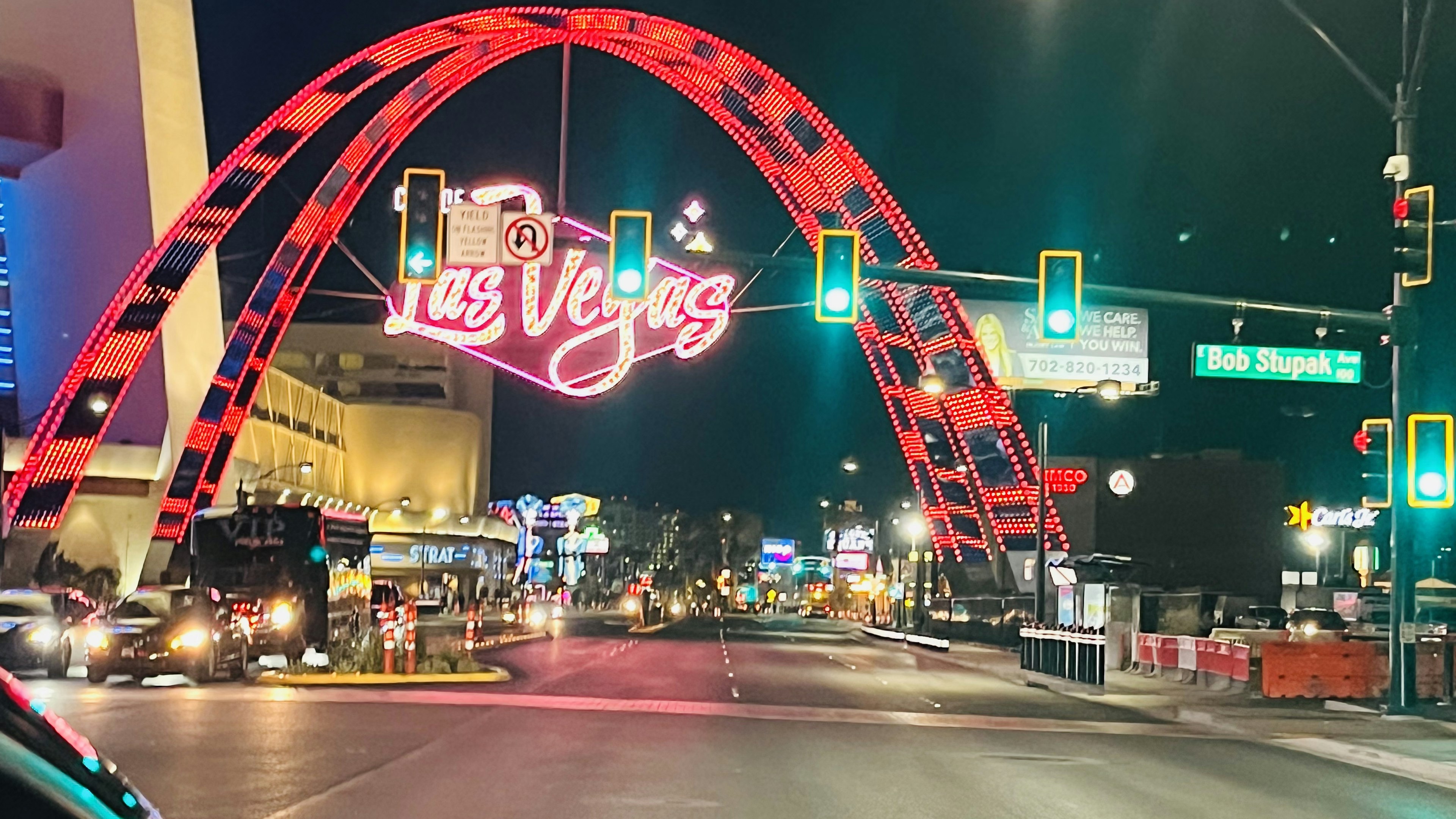 Iconic arch and neon sign of Las Vegas at night