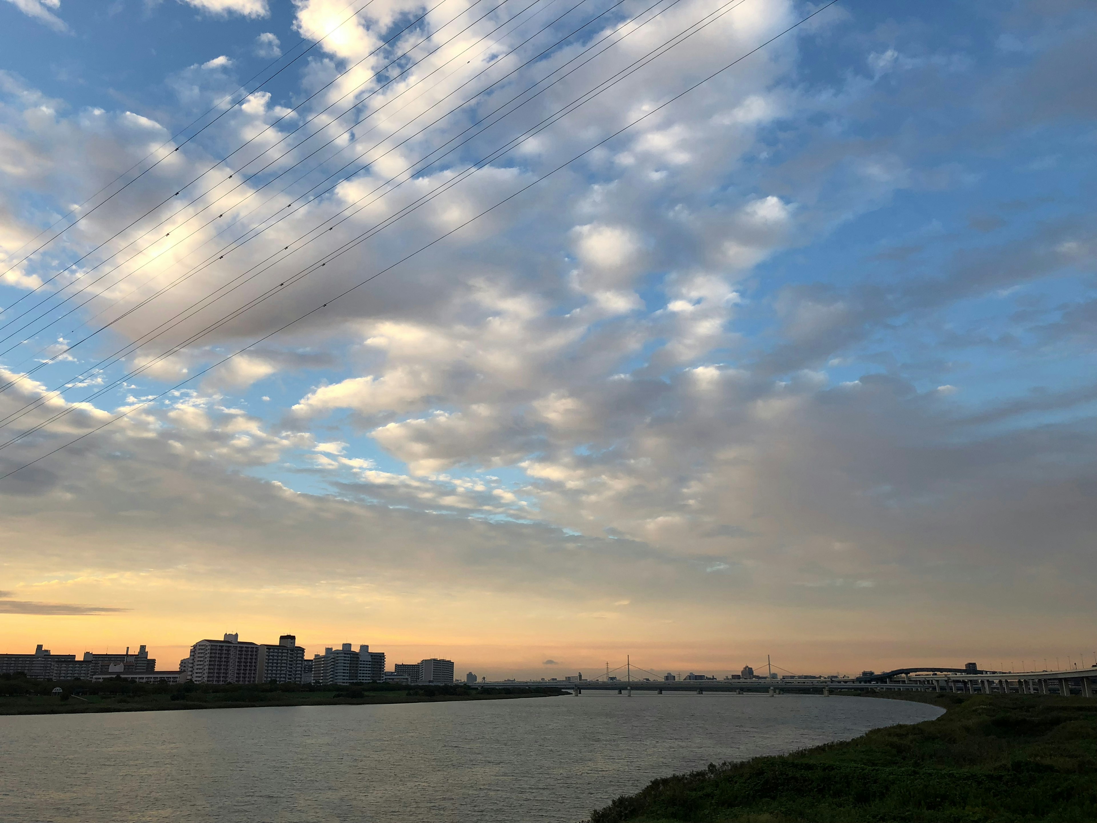 River landscape with expansive blue sky and clouds