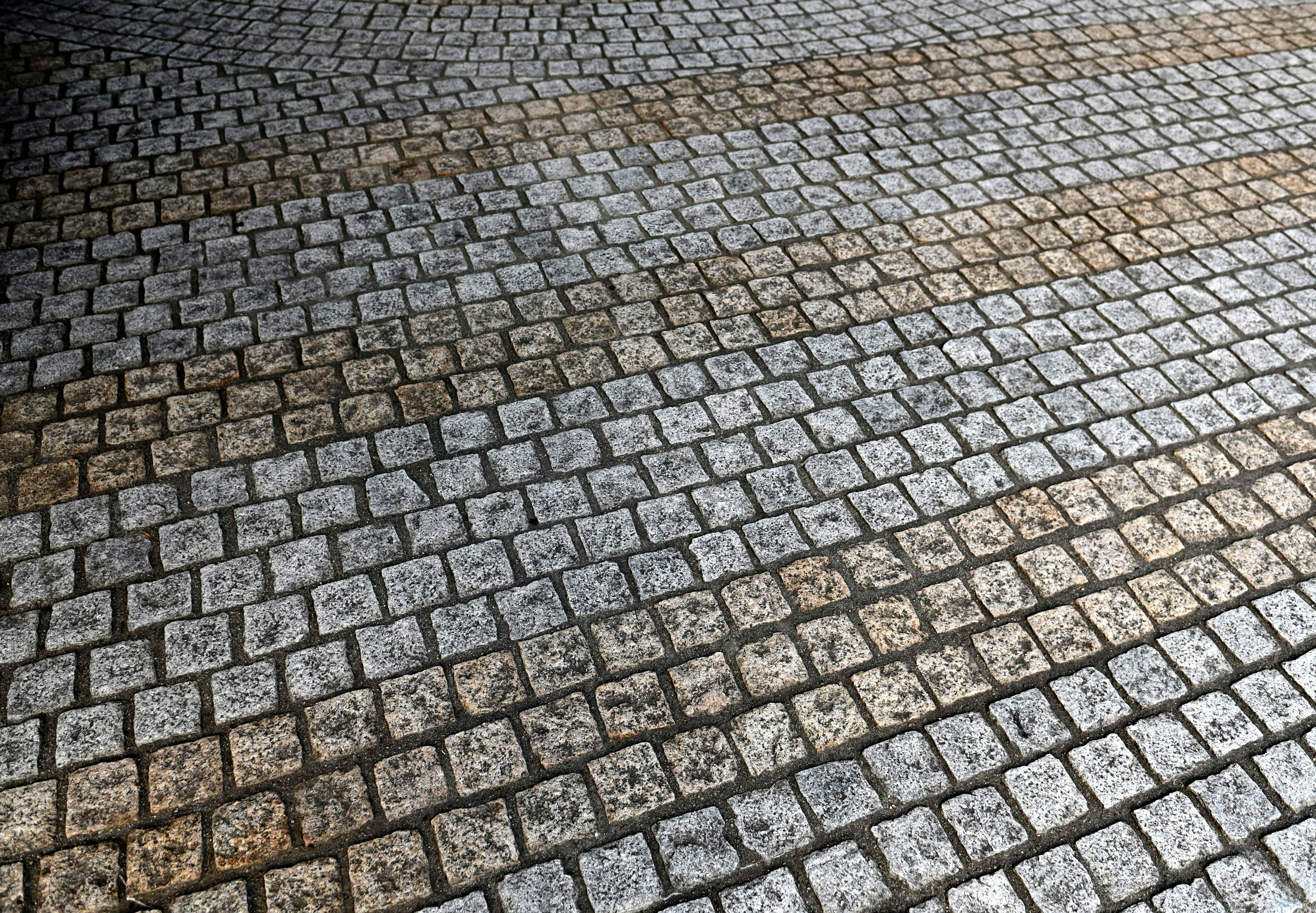 Close-up of cobblestone pavement featuring gray stones arranged neatly