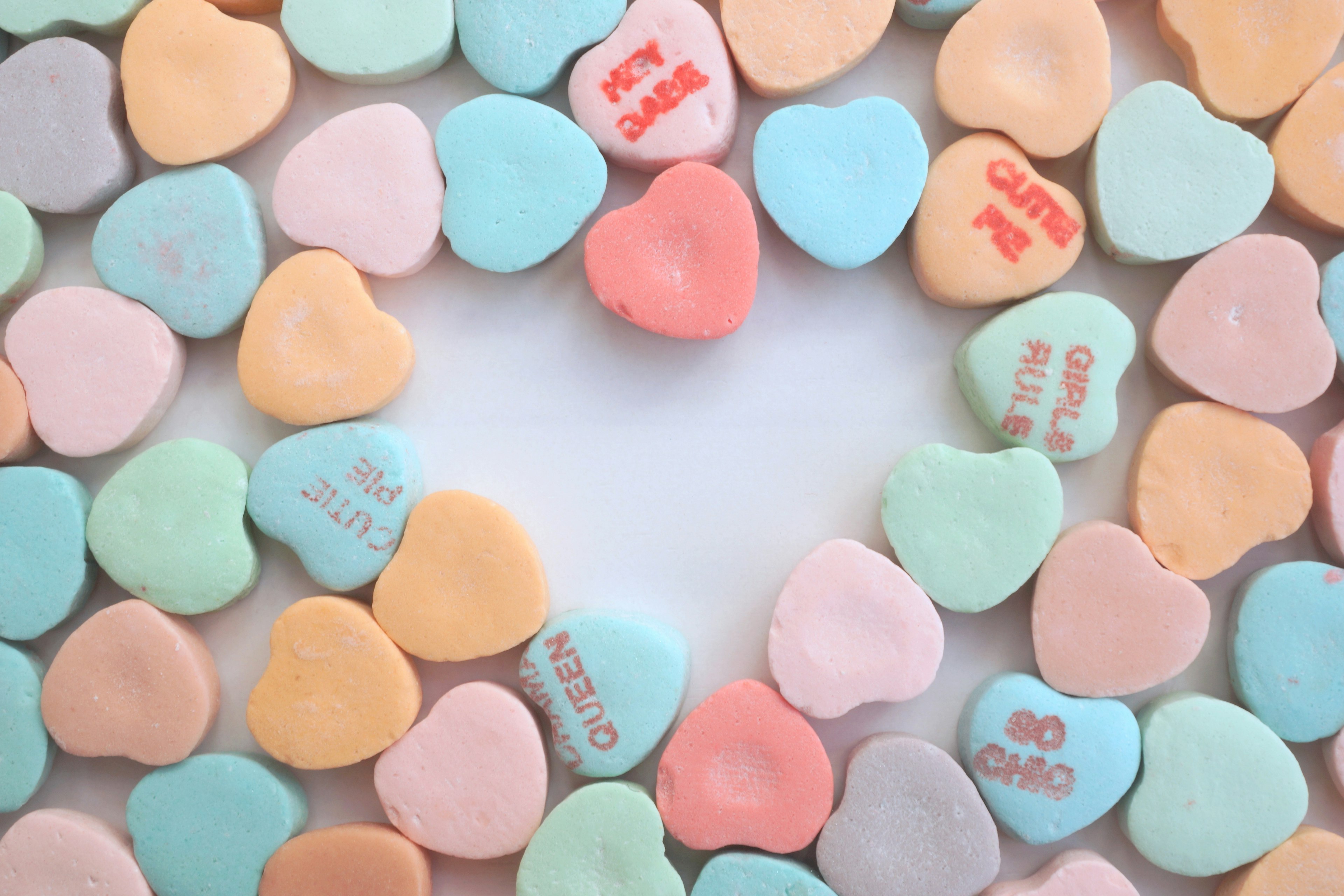 Colorful heart-shaped candies arranged in a circular pattern