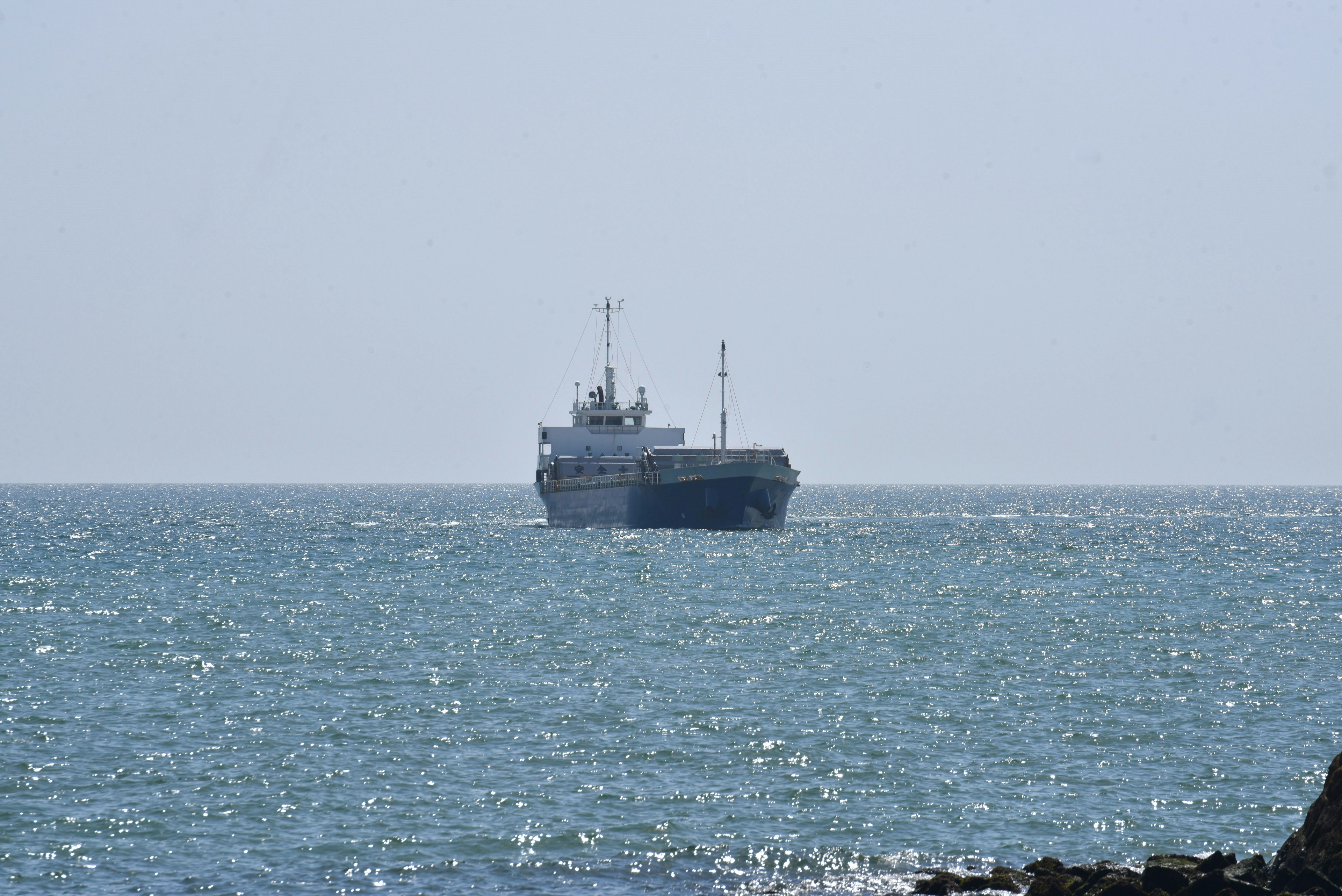 Silhouette eines Frachtschiffs, das auf dem Meer segelt