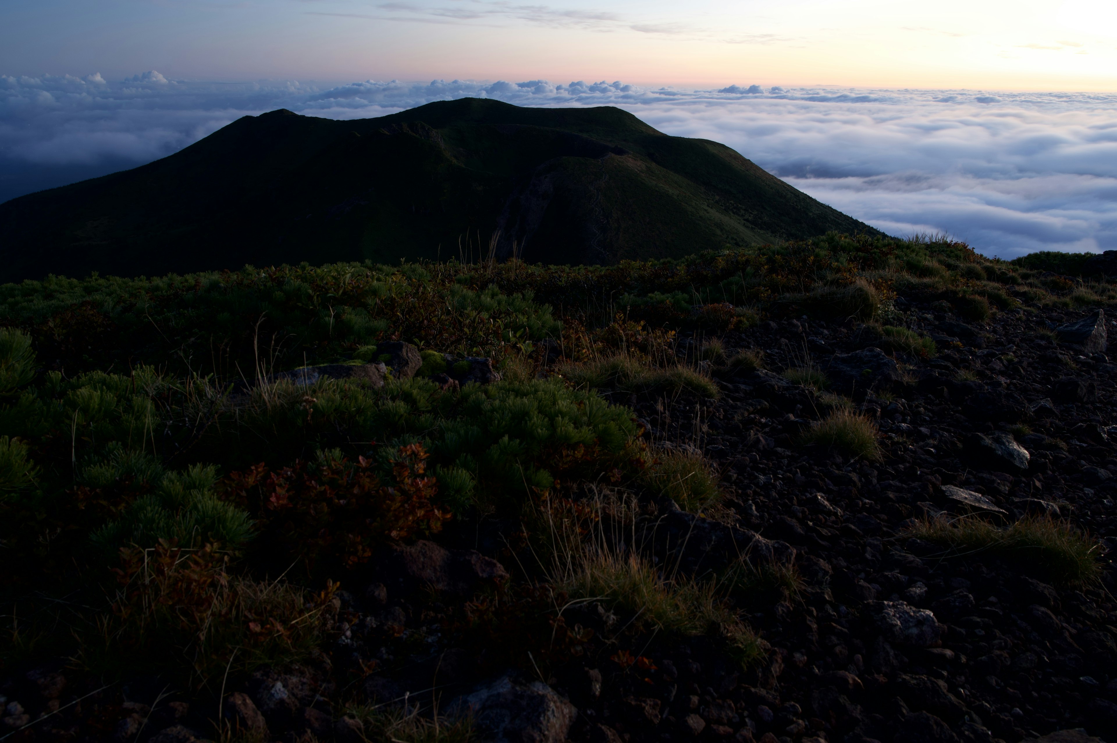 Mountain landscape with a sea of clouds at dusk