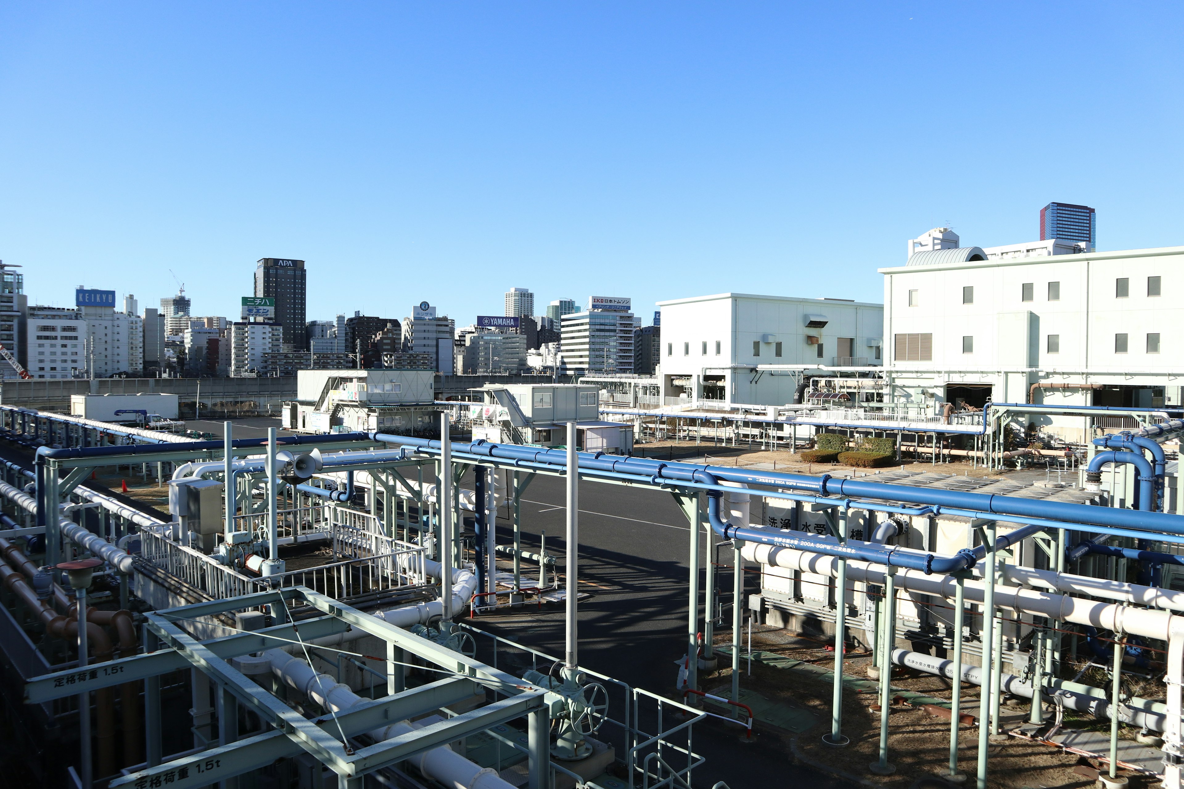 View from rooftop of an industrial facility showcasing equipment and pipes