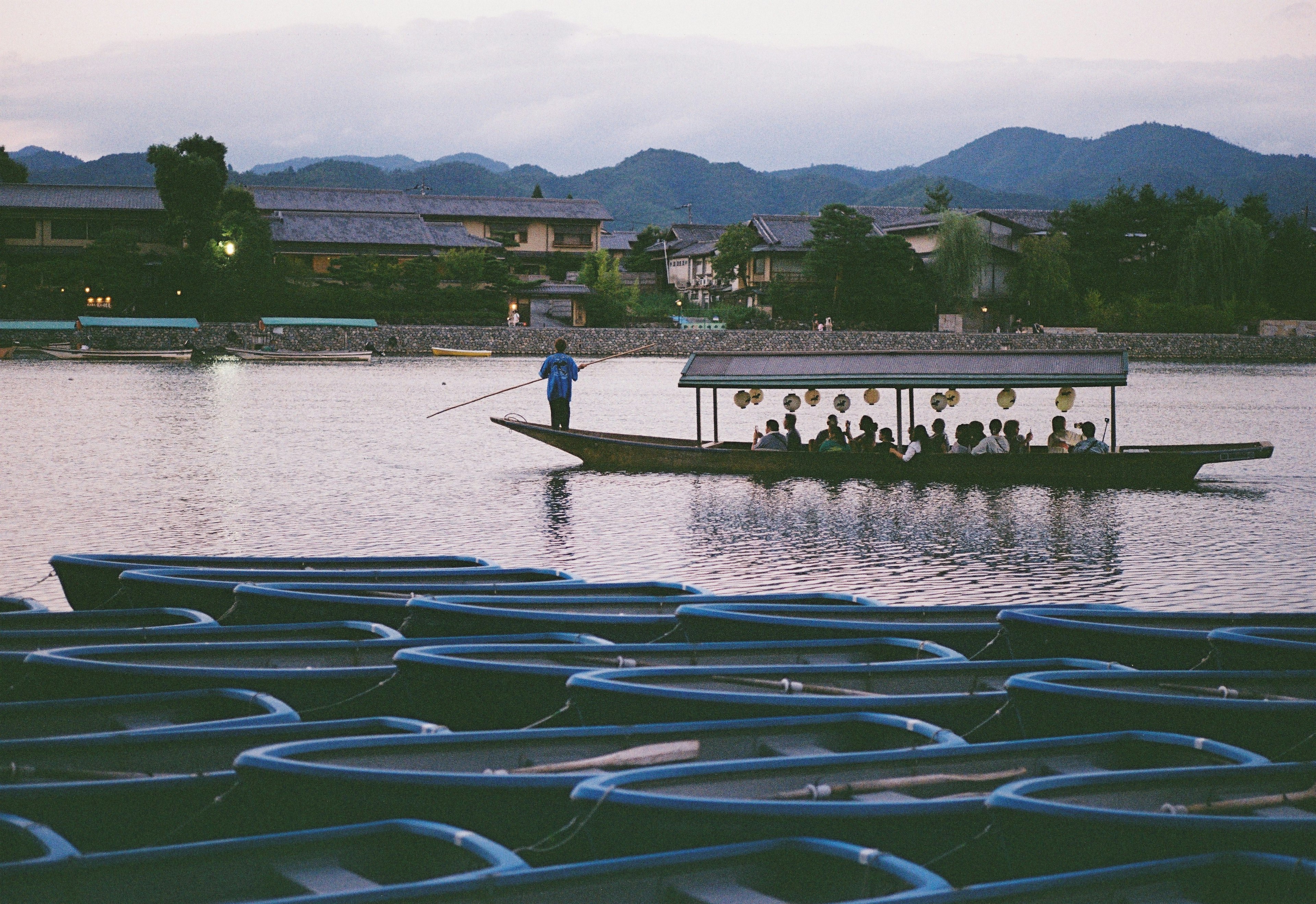 Blue boats on a lake with people in a boat