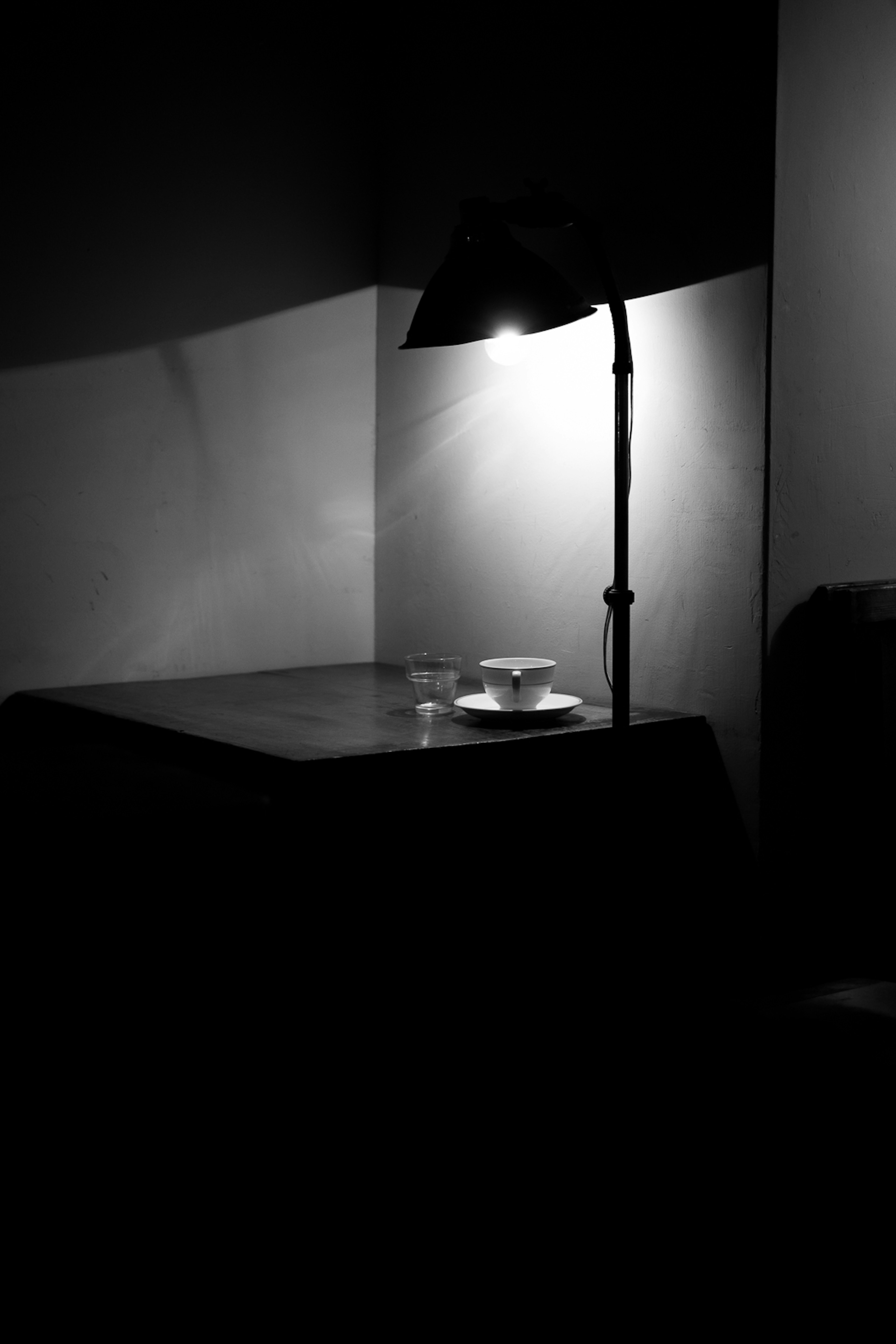 Silhouette of a table and lamp in a dark room