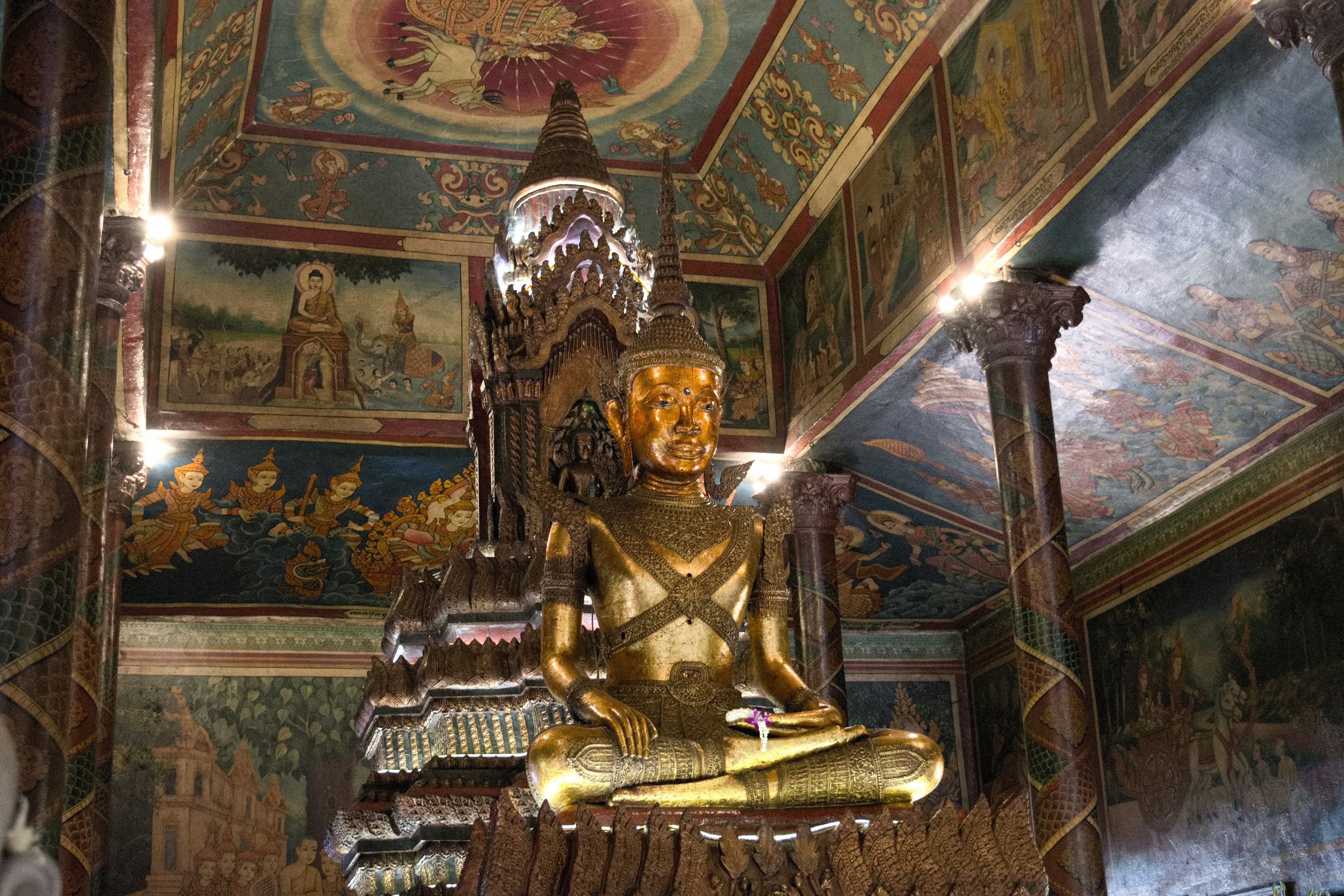 Interior of a temple featuring a golden Buddha statue