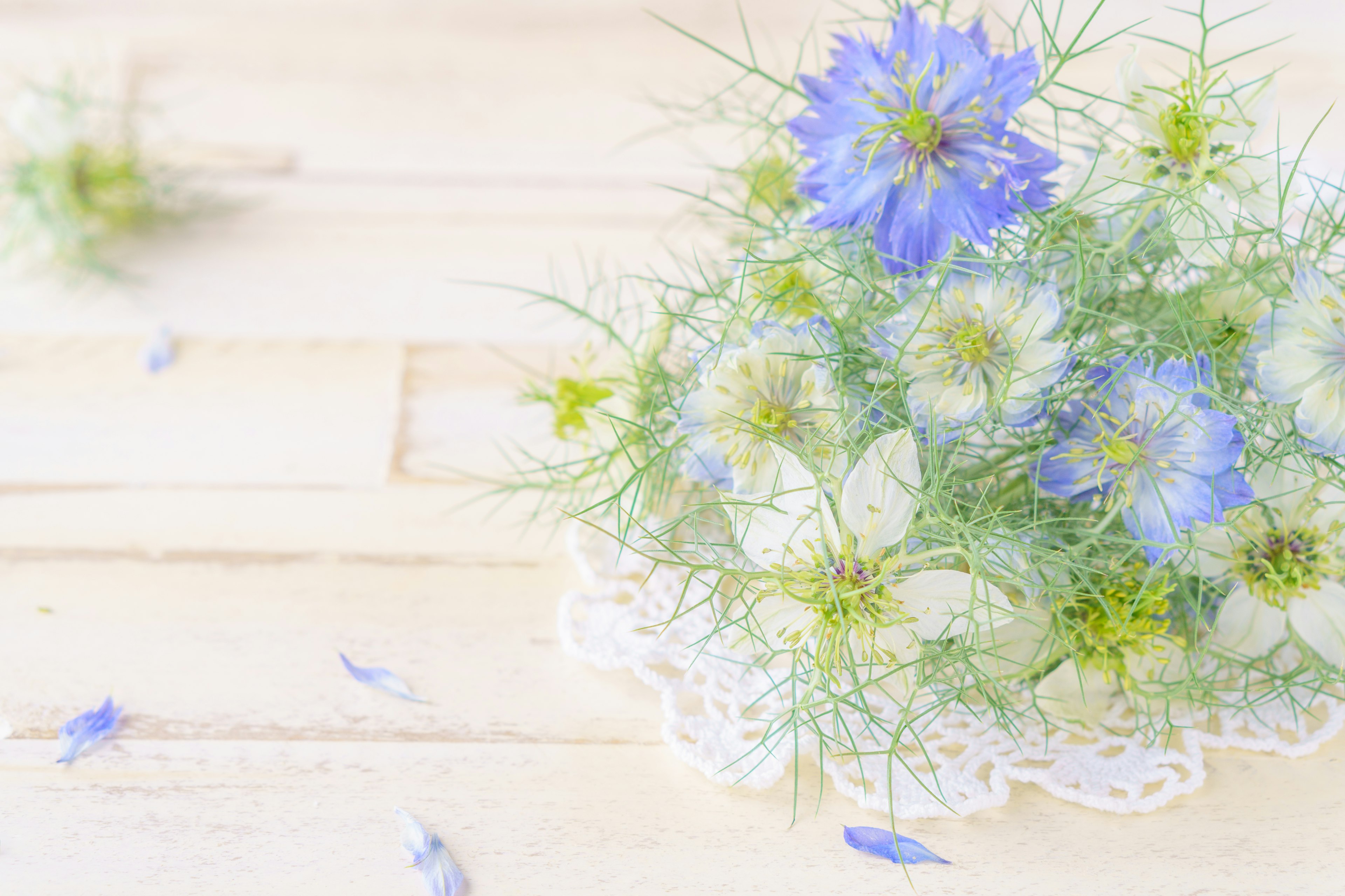 Arrangement of blue and white flowers on a wooden table