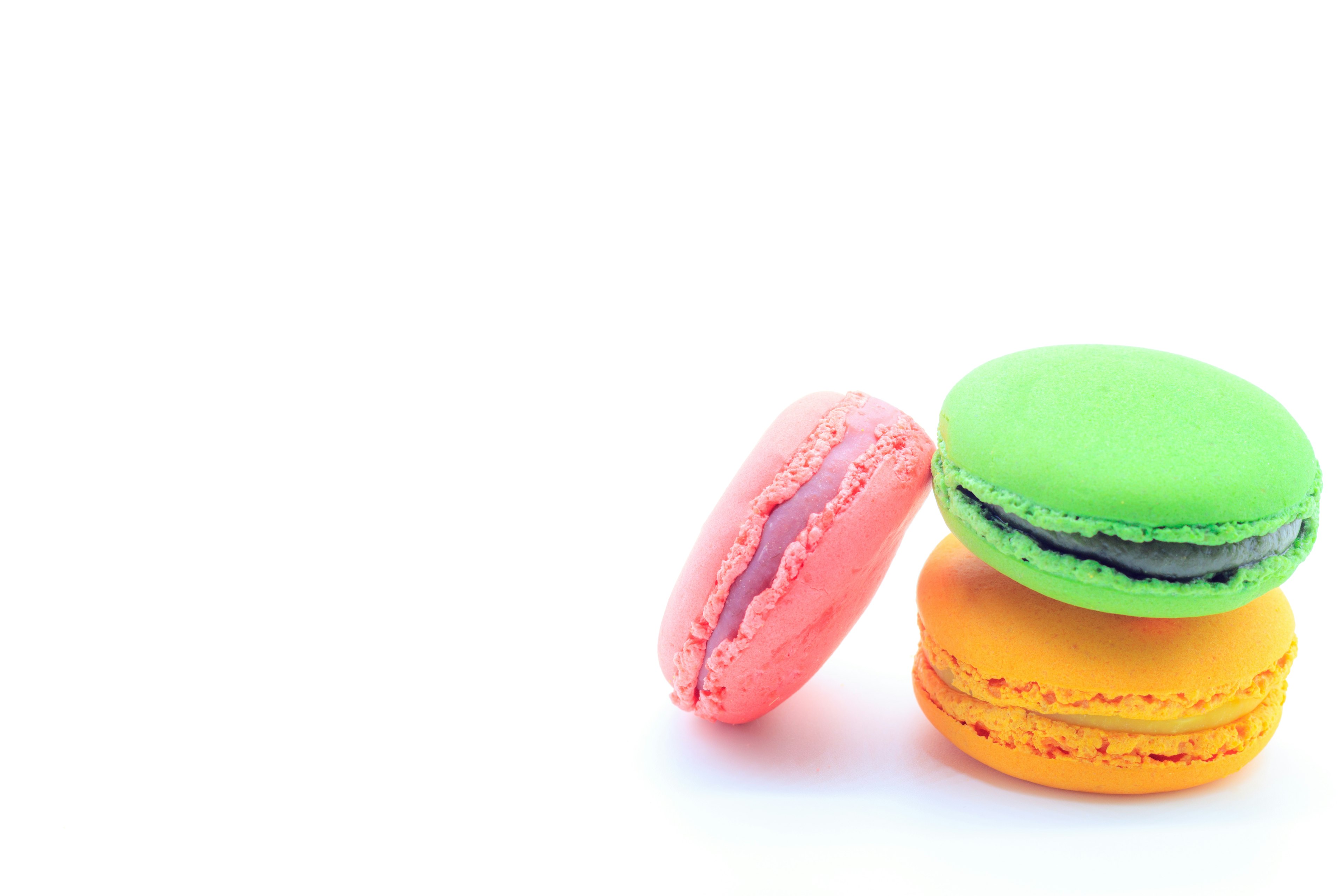 Colorful macarons stacked on a white background