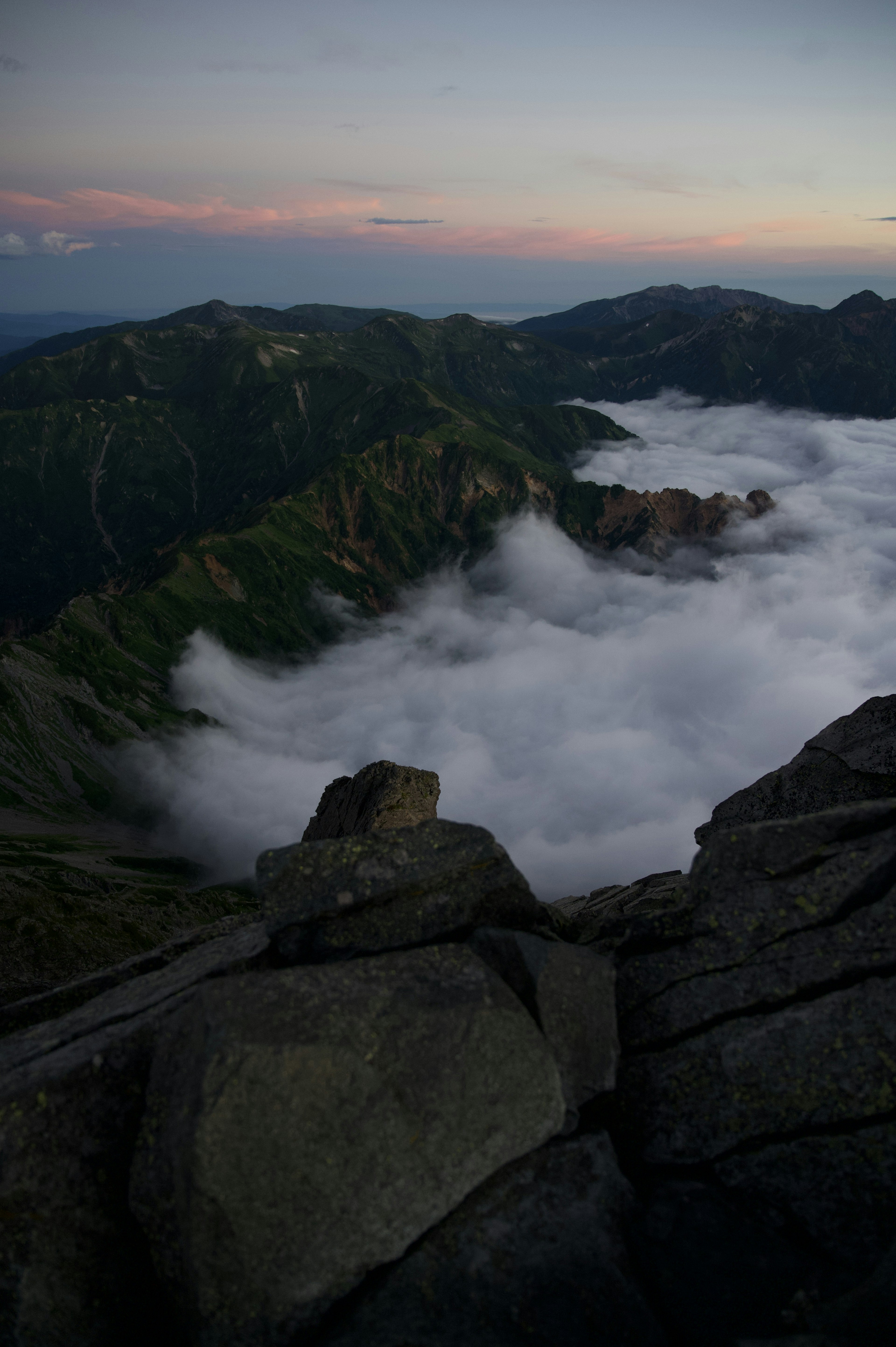 View of a sea of clouds and sunset from a mountain peak