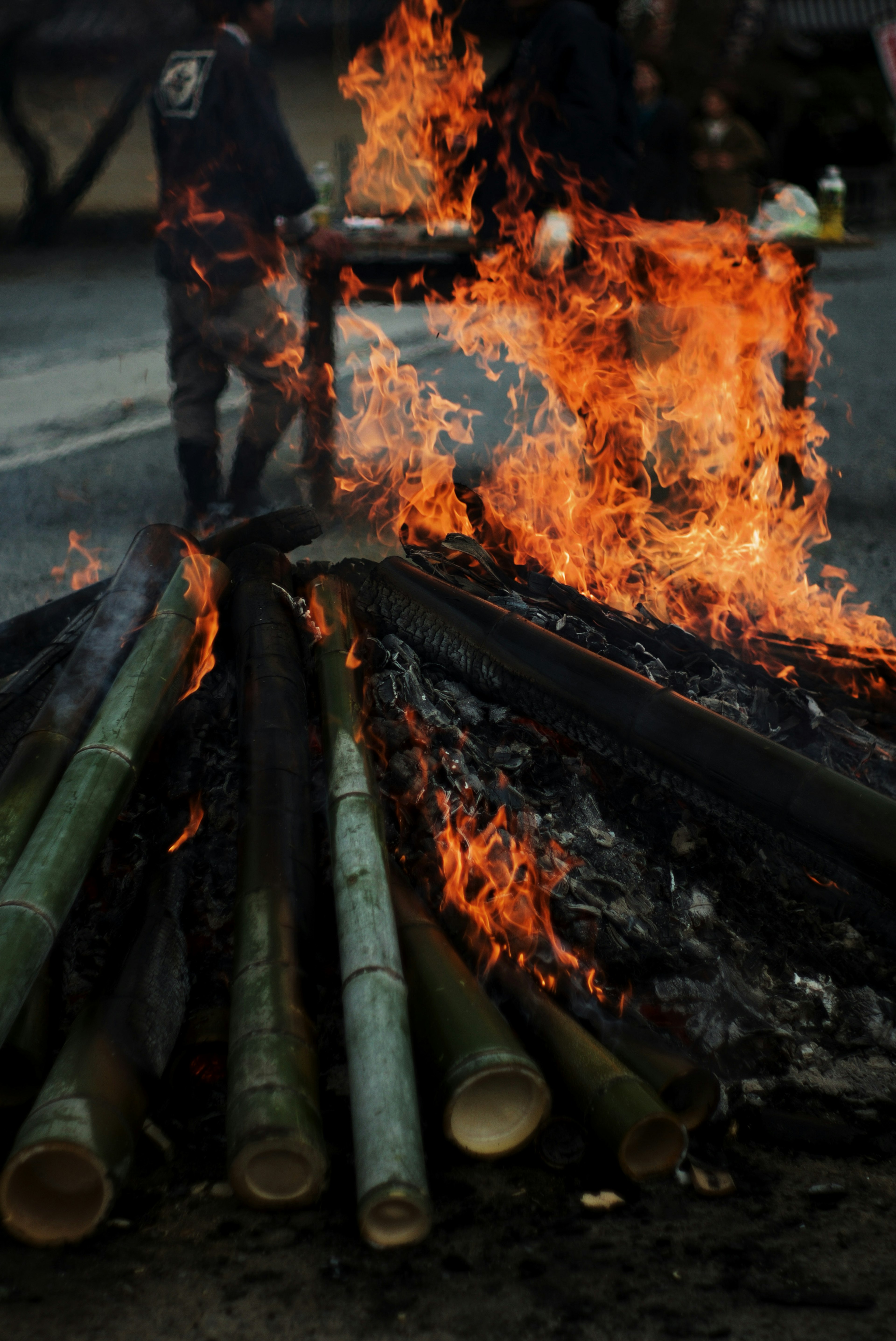 Burning bamboo logs with flames surrounding them