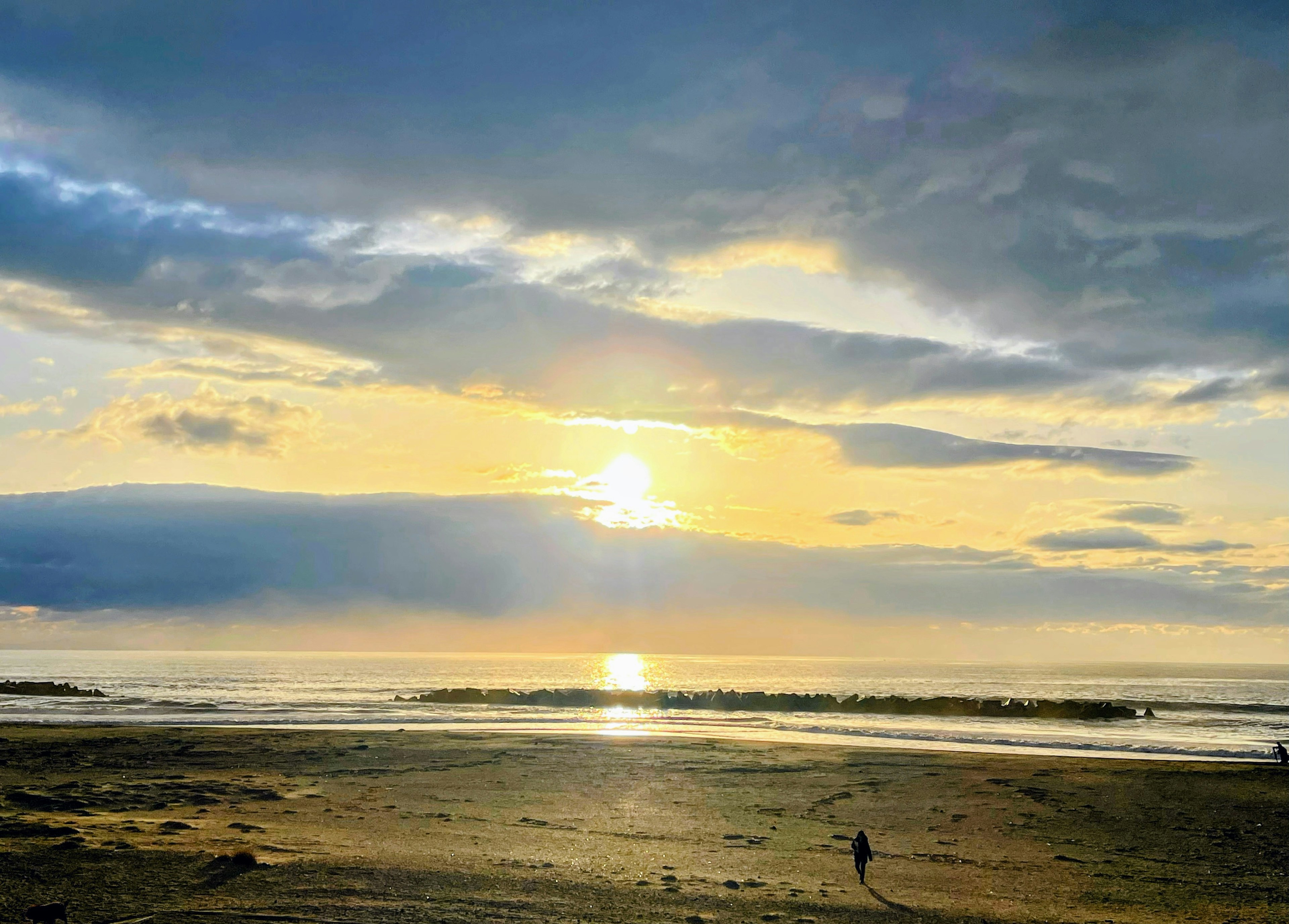 Beautiful beach scene with sunset reflecting on the water