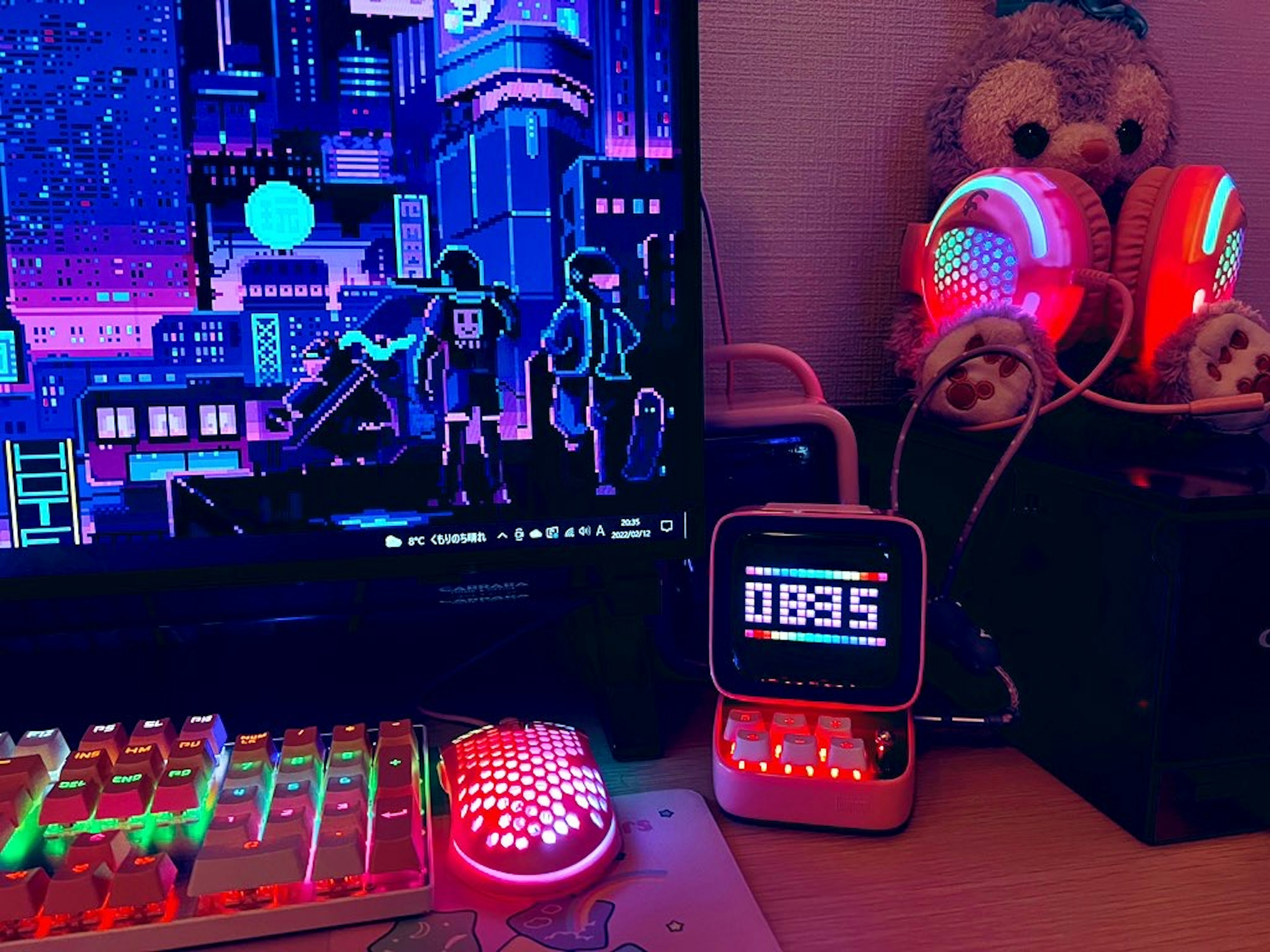 Colorful gaming setup featuring LED lights and a digital clock