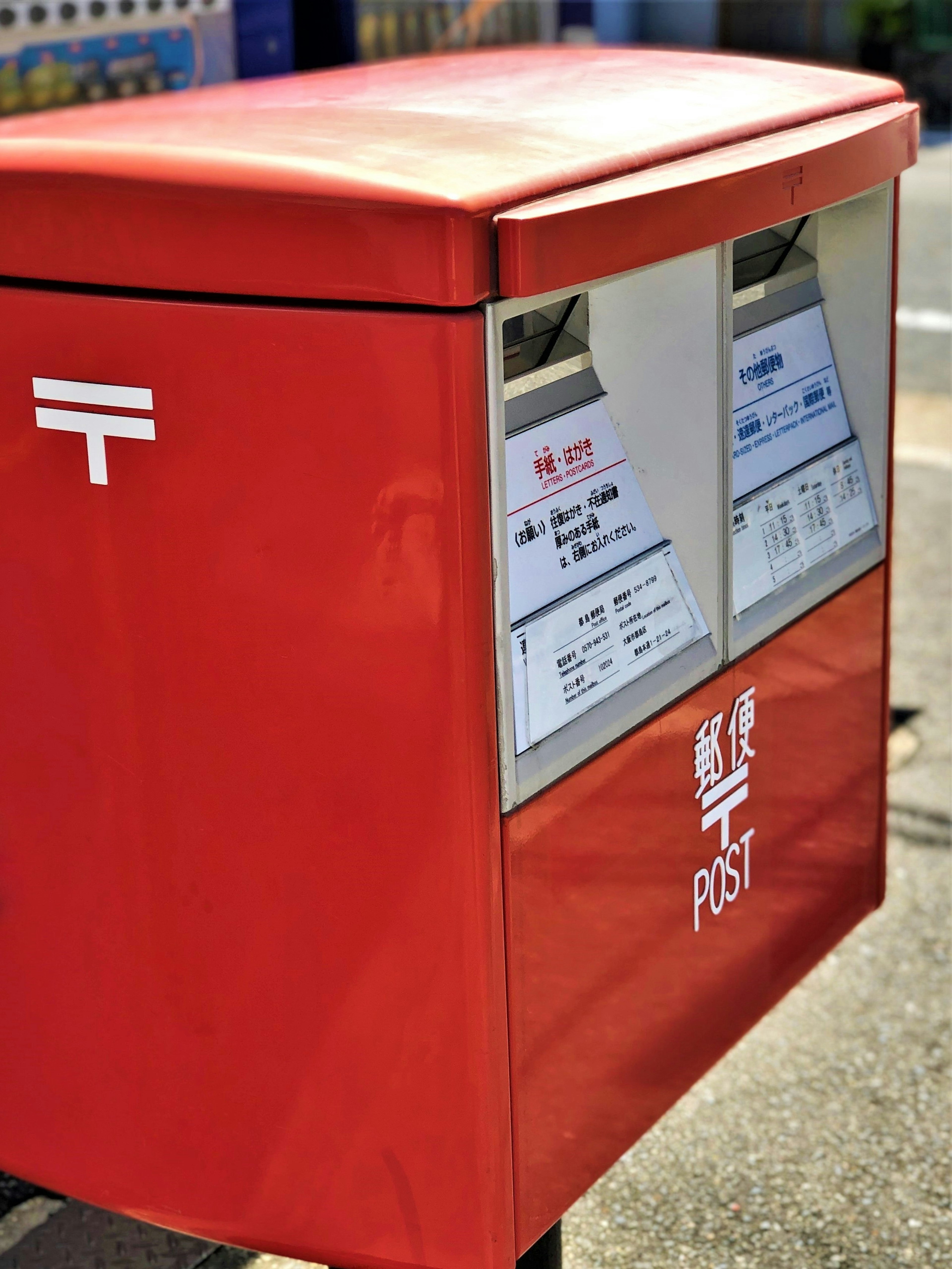 Image of a red mailbox featuring Japanese postal markings