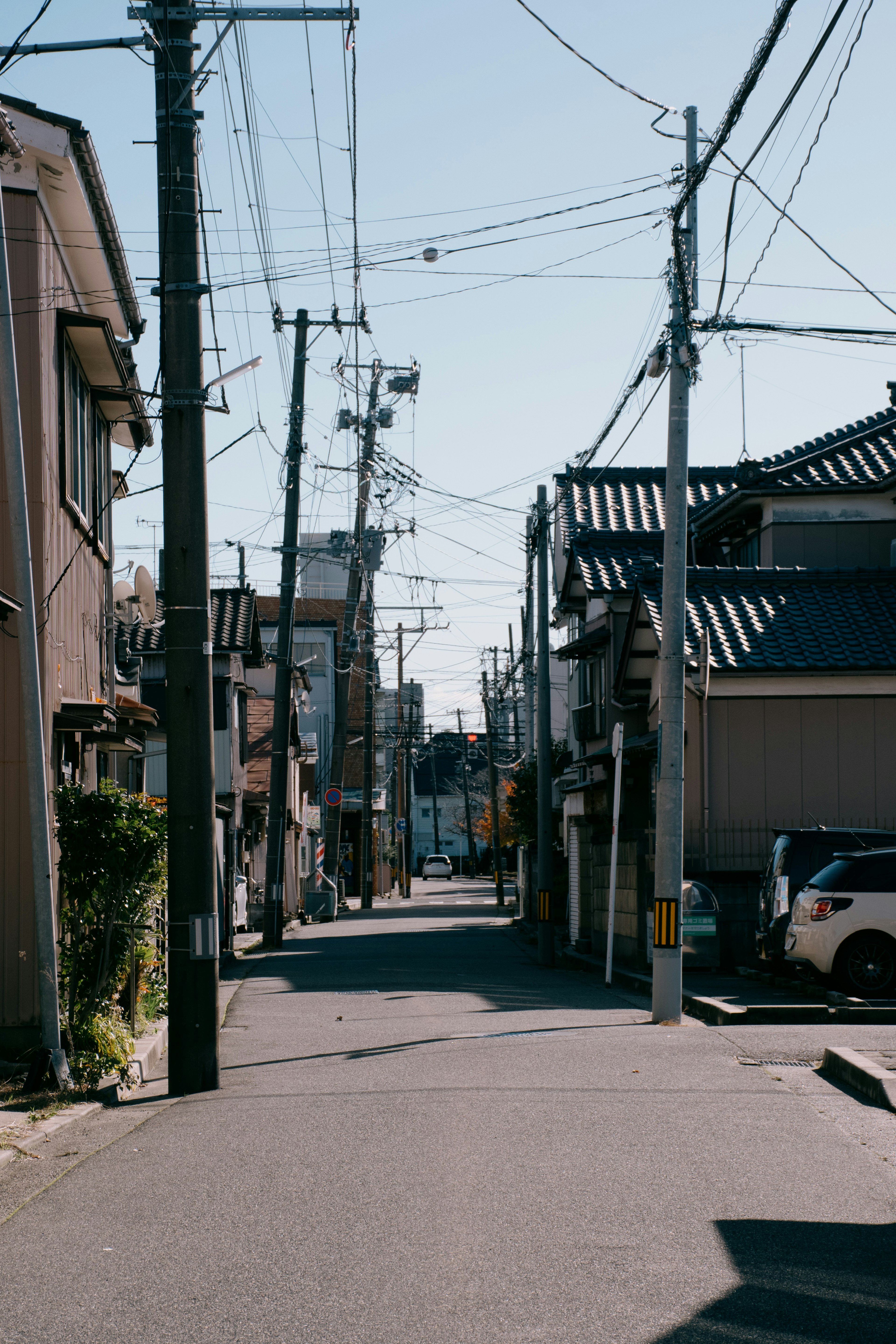 Quiet street scene with utility poles and traditional buildings