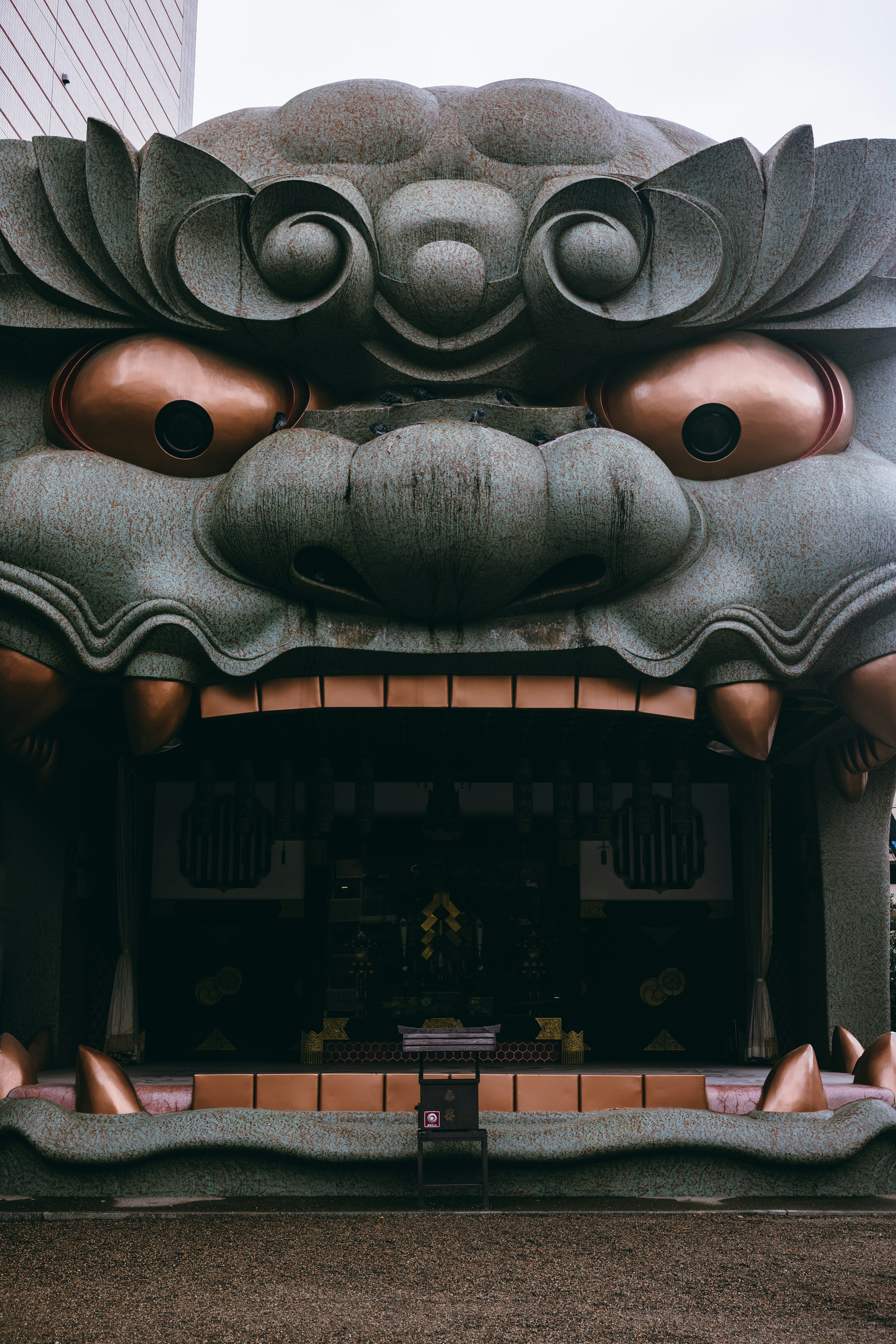 Large lion face sculpture at the entrance of a building