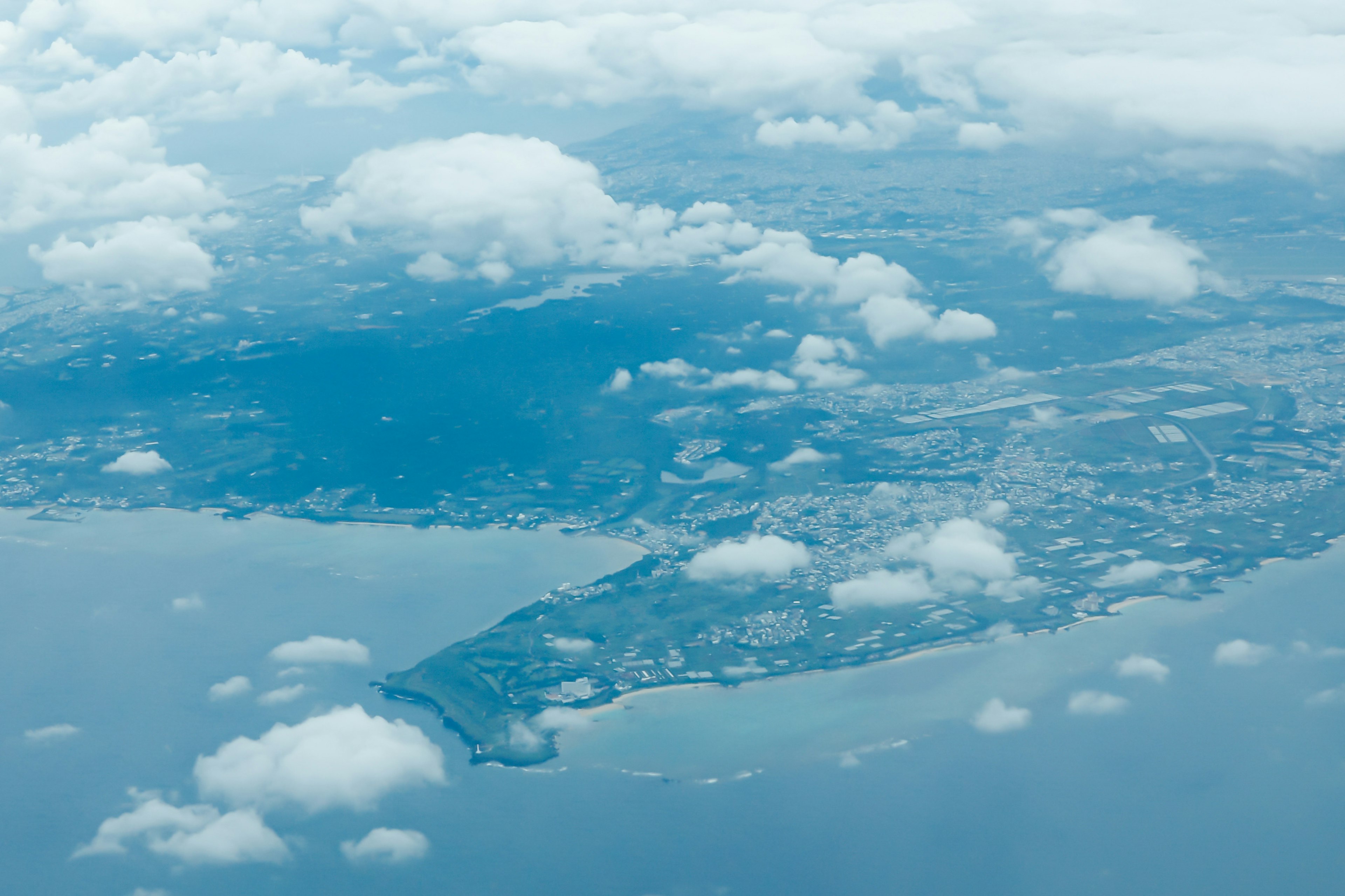 Aerial view of coastline and clouds