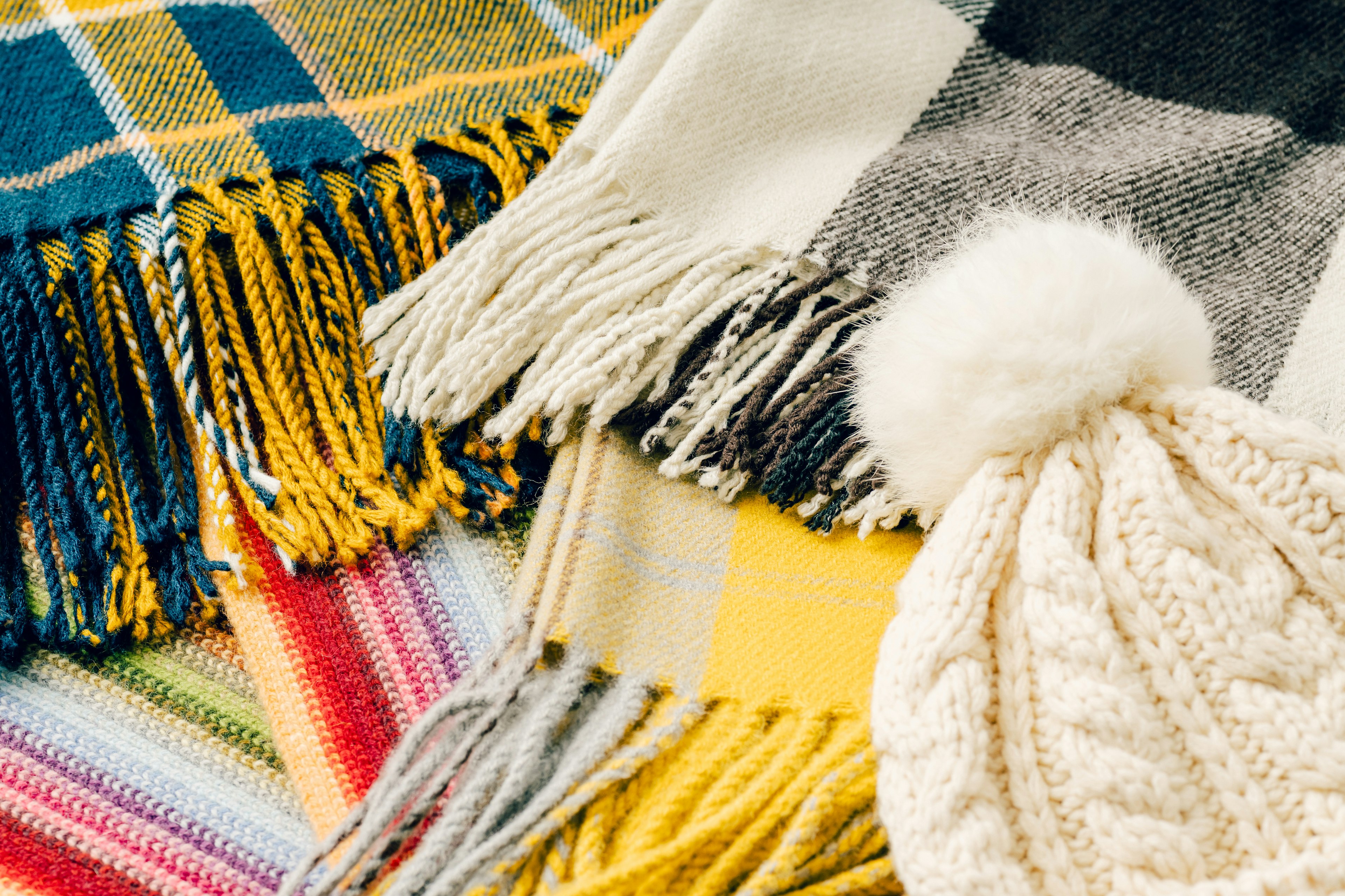 Close-up of colorful scarves and a knit hat