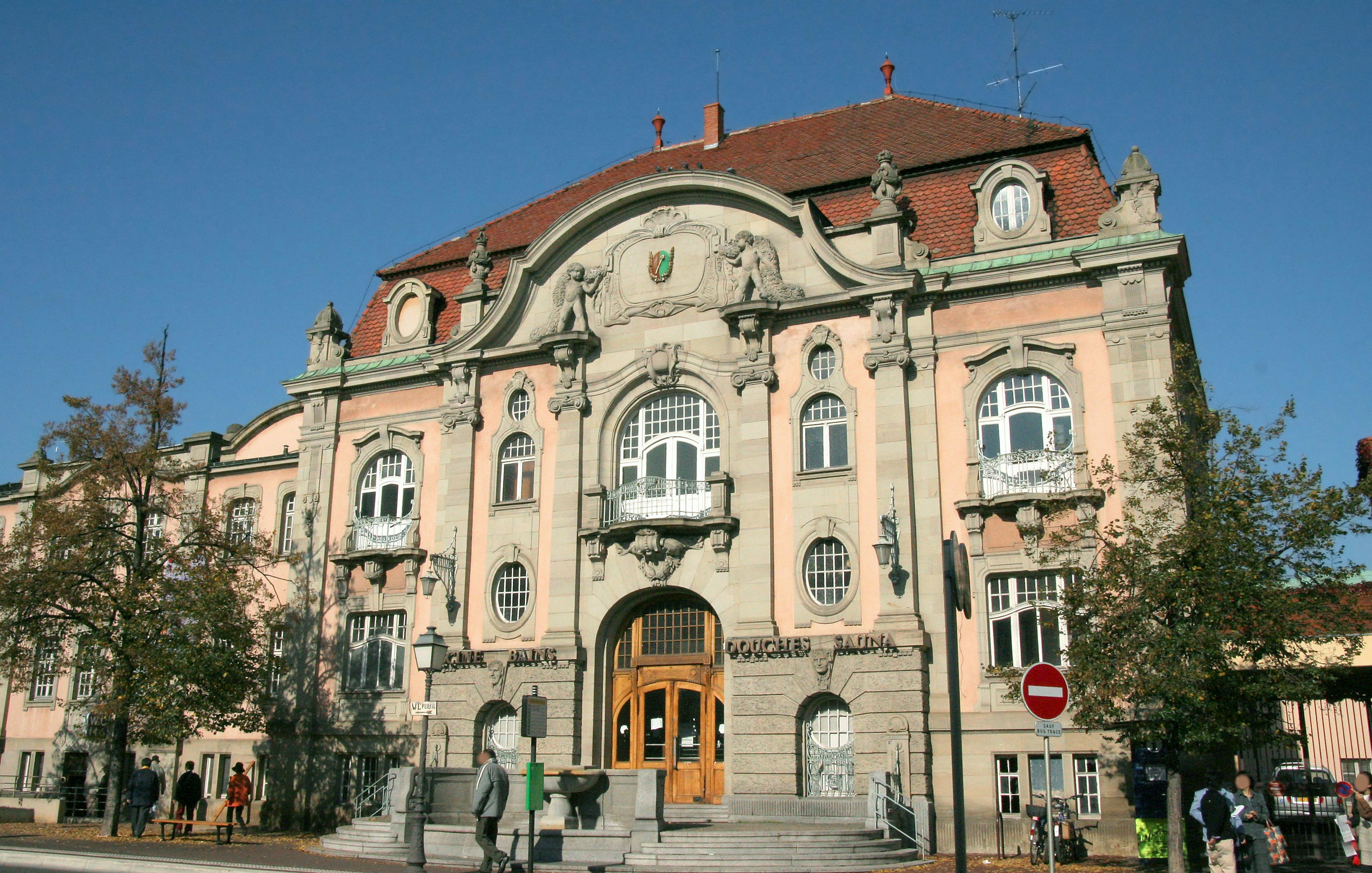 The beautiful building features a decorative facade and a red roof