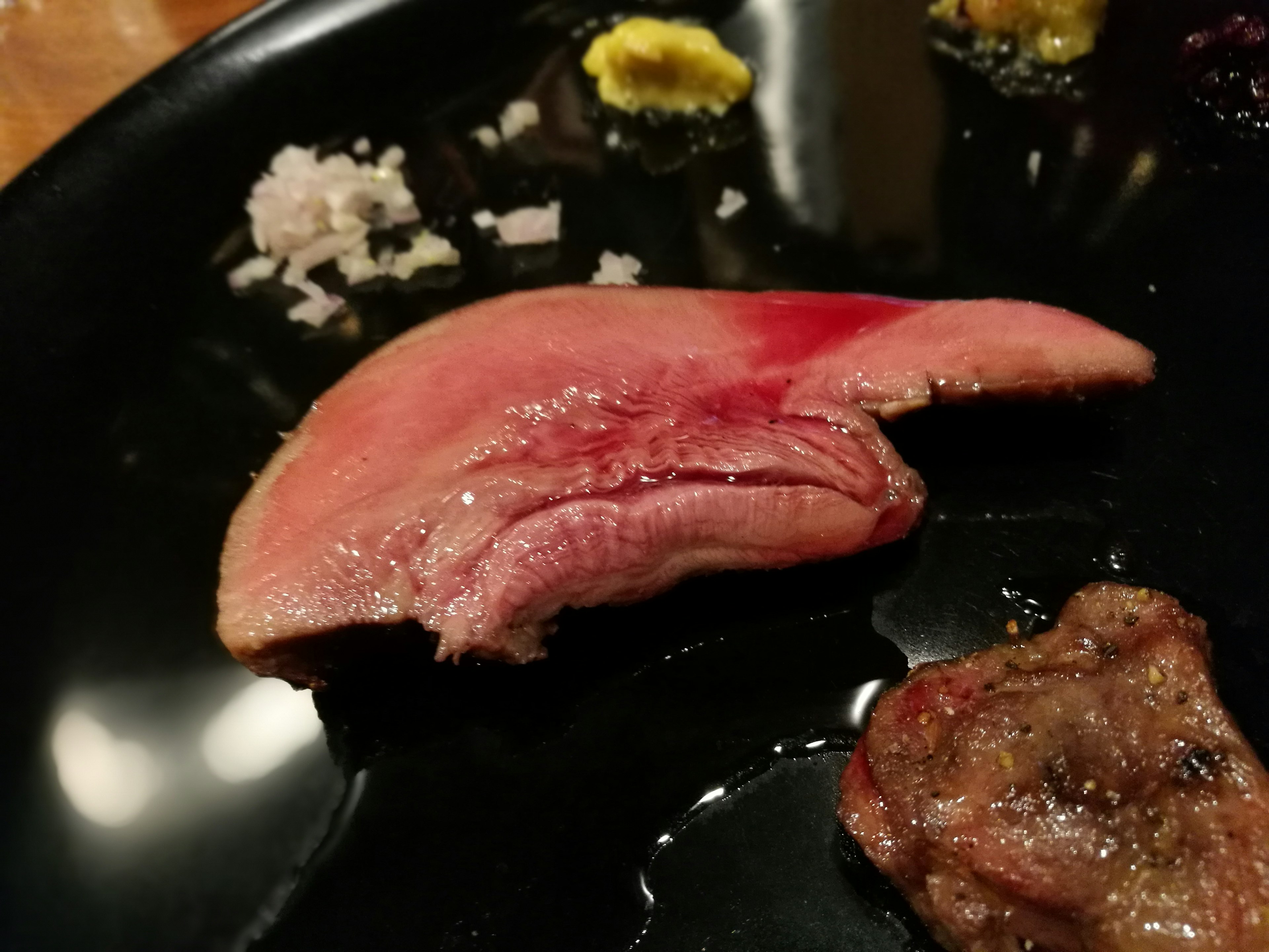 皿の上にある薄切りの肉の提供美しい赤色と質感