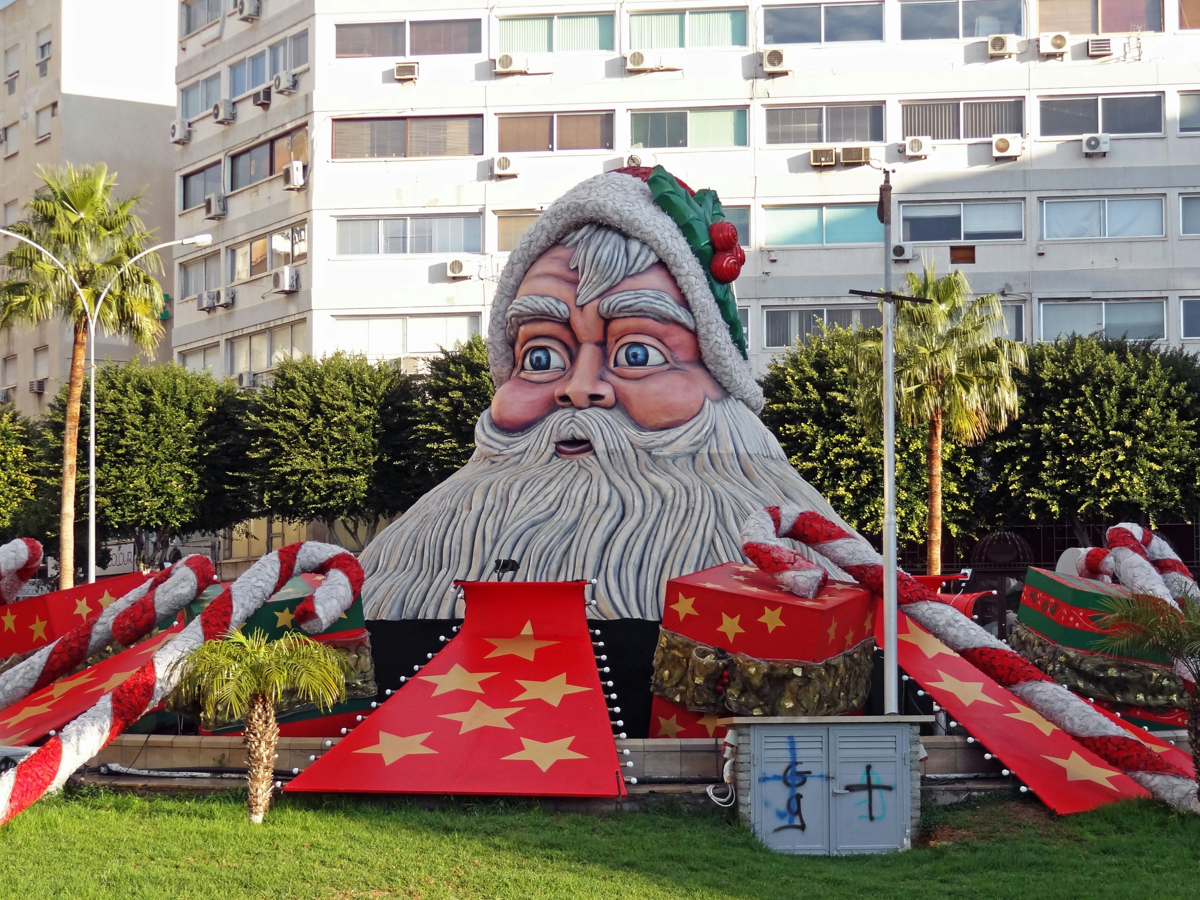 Giant Santa Claus decoration with red themed Christmas elements