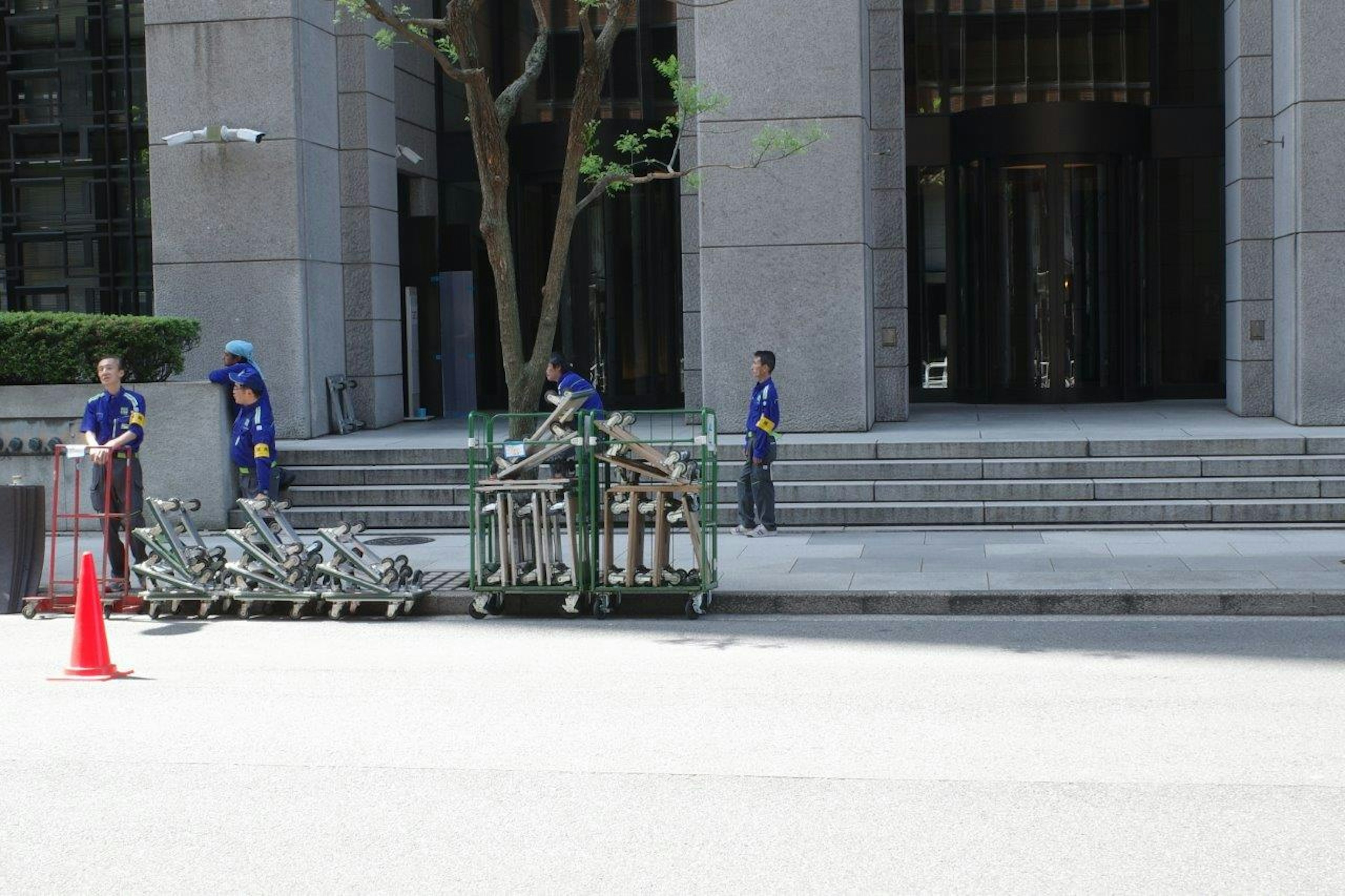 Workers handling equipment in an urban setting