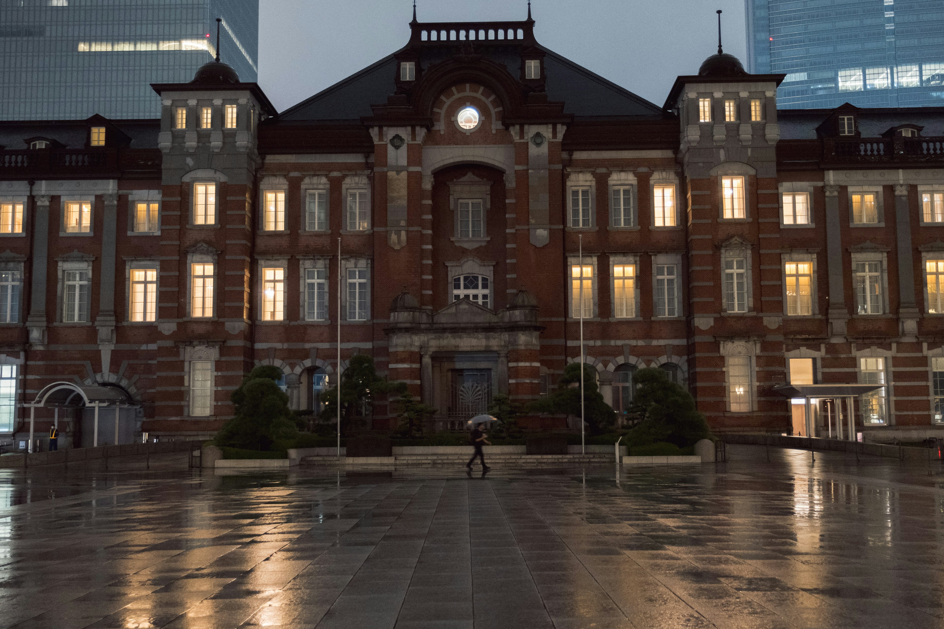 Tokyo Station's stunning facade with a rain-soaked plaza