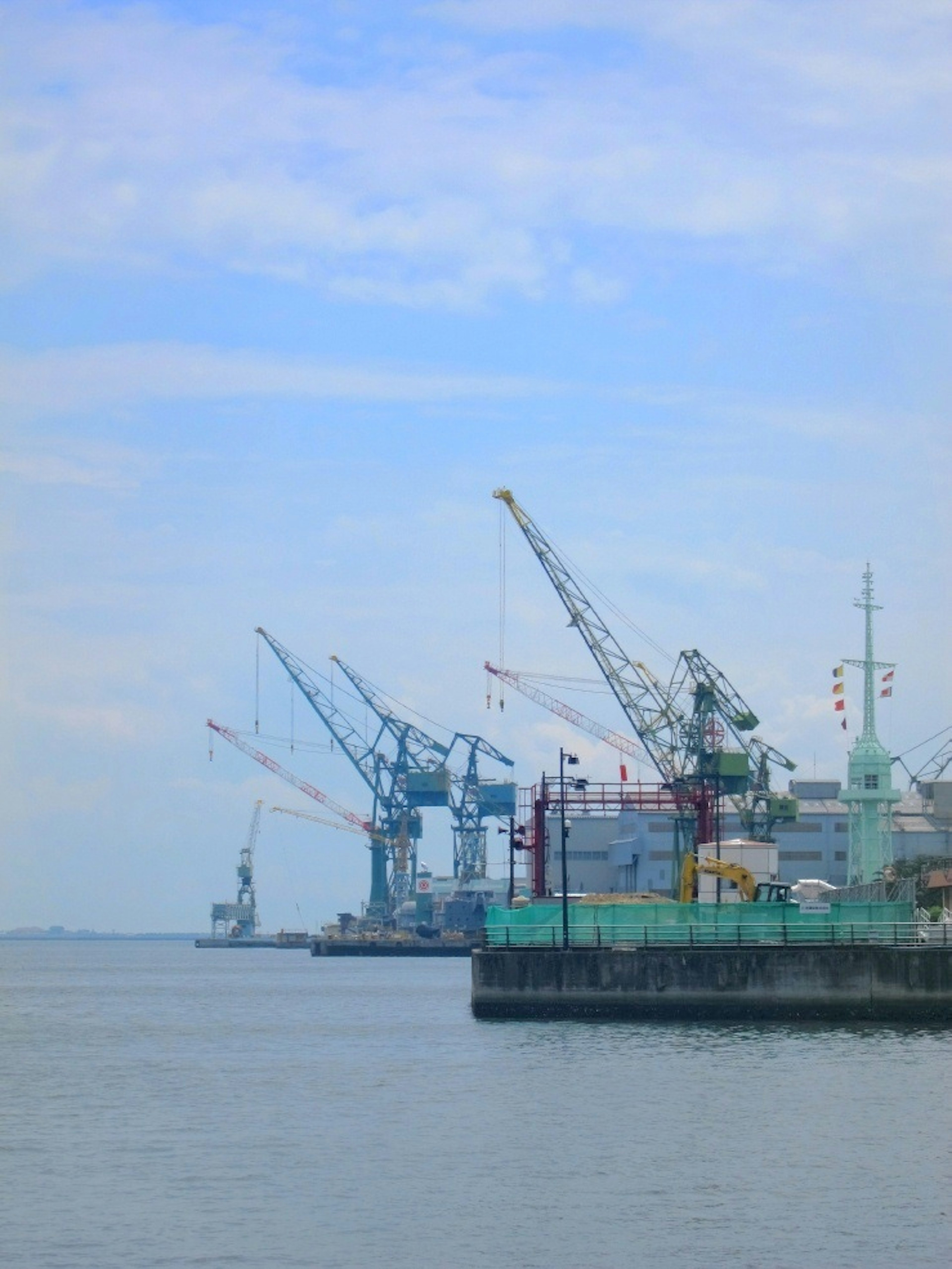 View of cranes and ships at a port