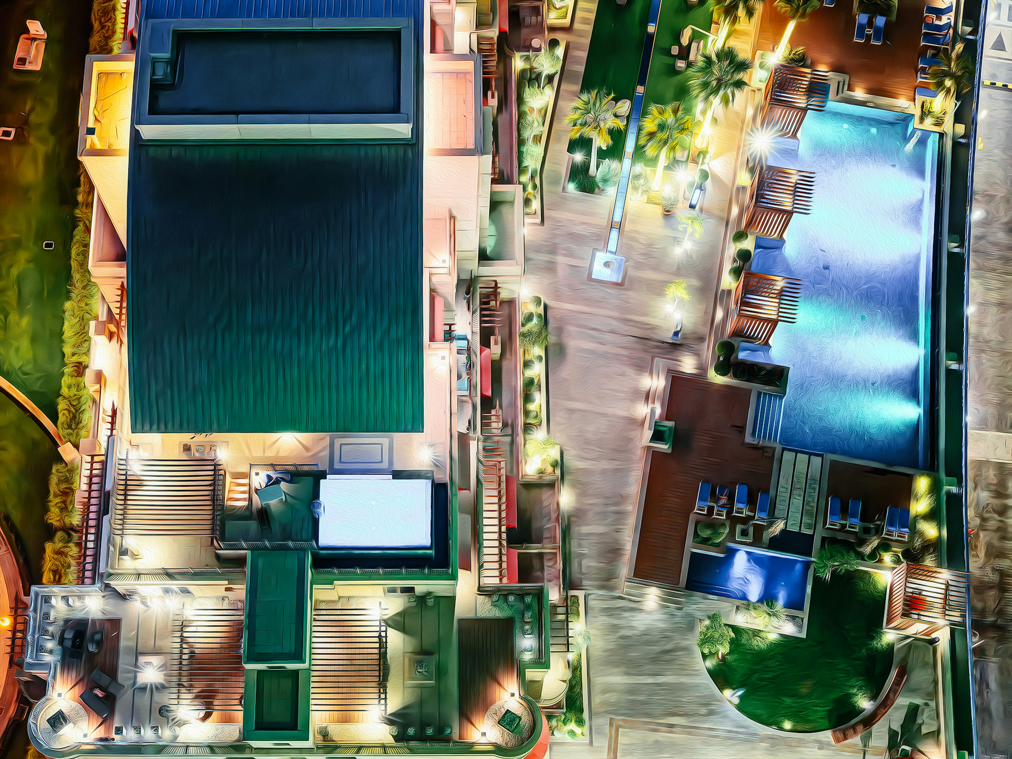 Vue aérienne d'un hôtel luxueux avec une piscine et des jardins paysagers la nuit