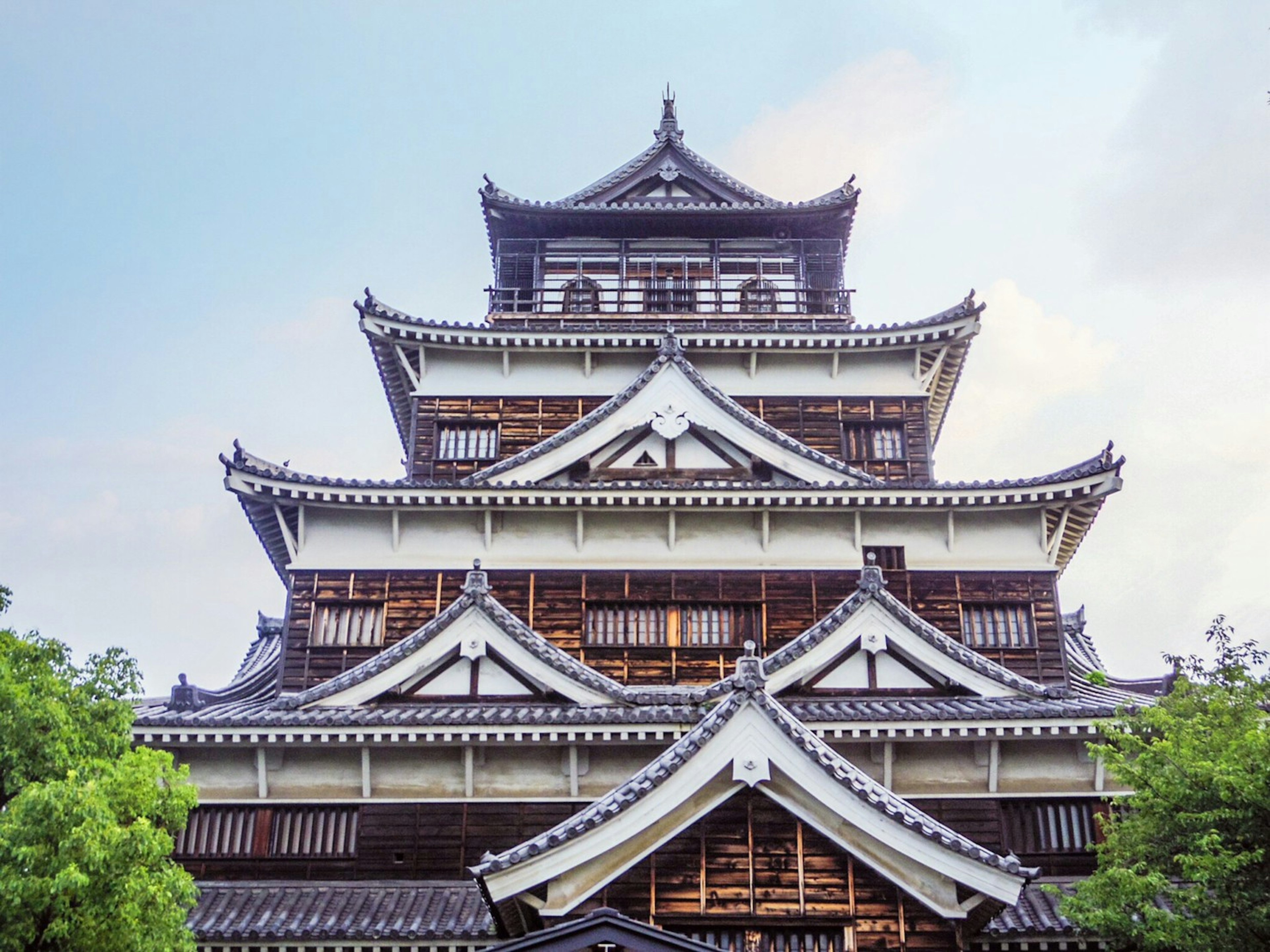 Japanese castle exterior with black and white tiled roofs