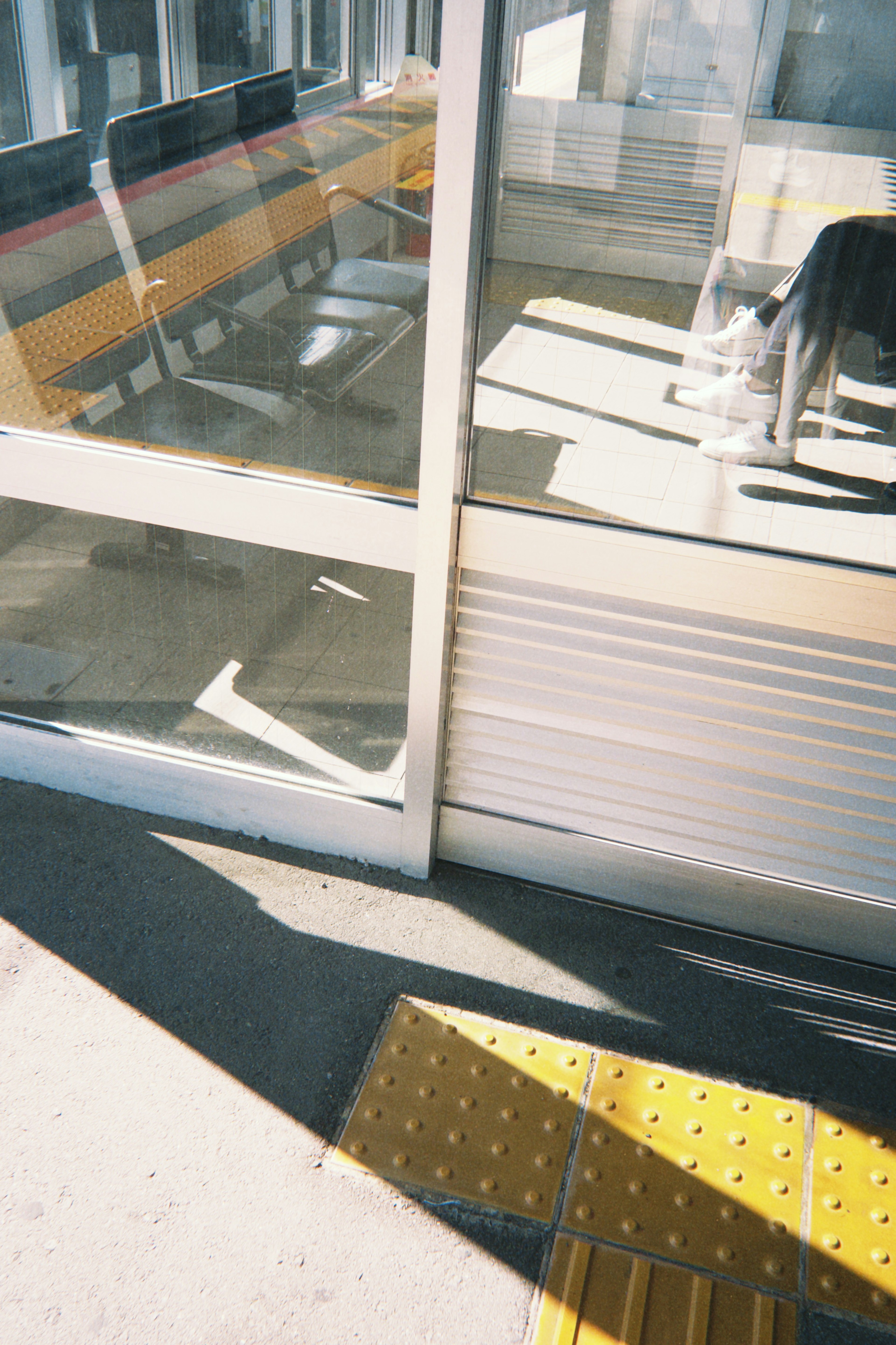 Photo of a station waiting area with windows and benches