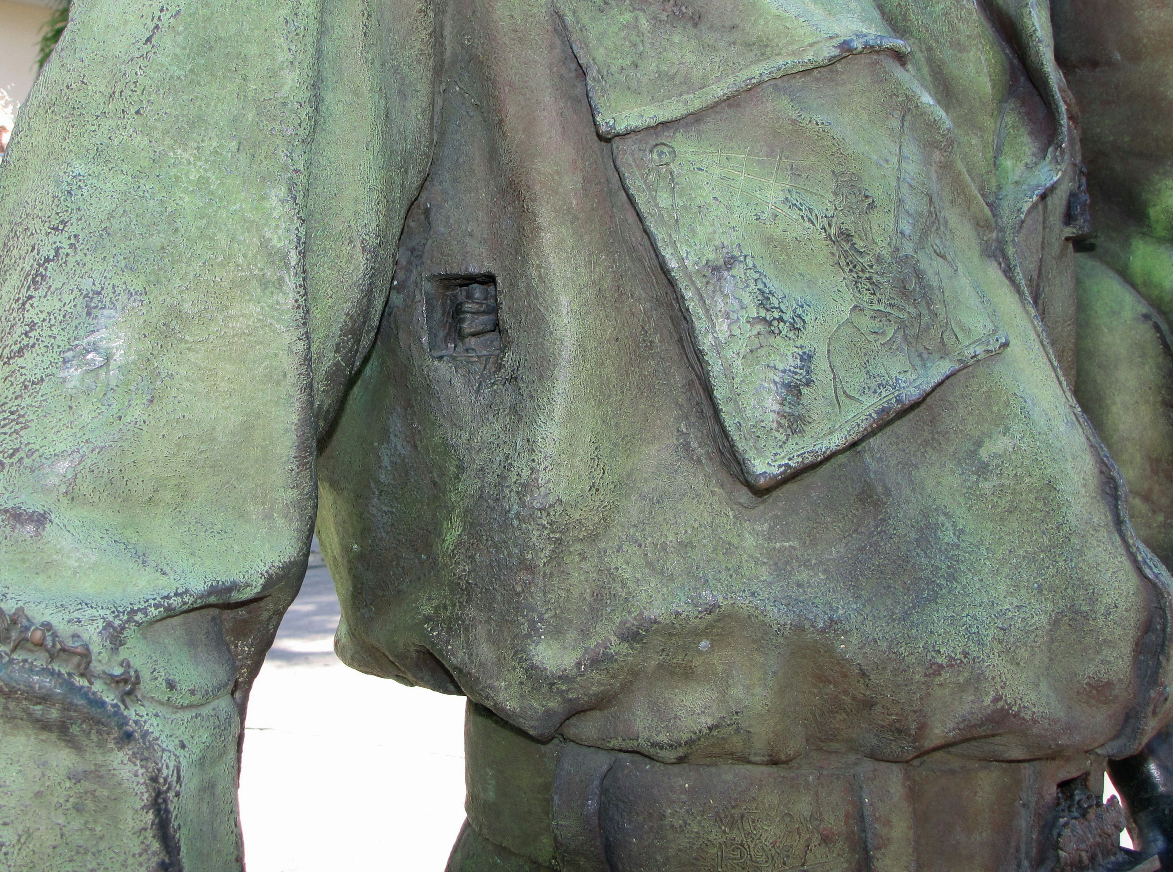 Detail of a green military uniform sculpture