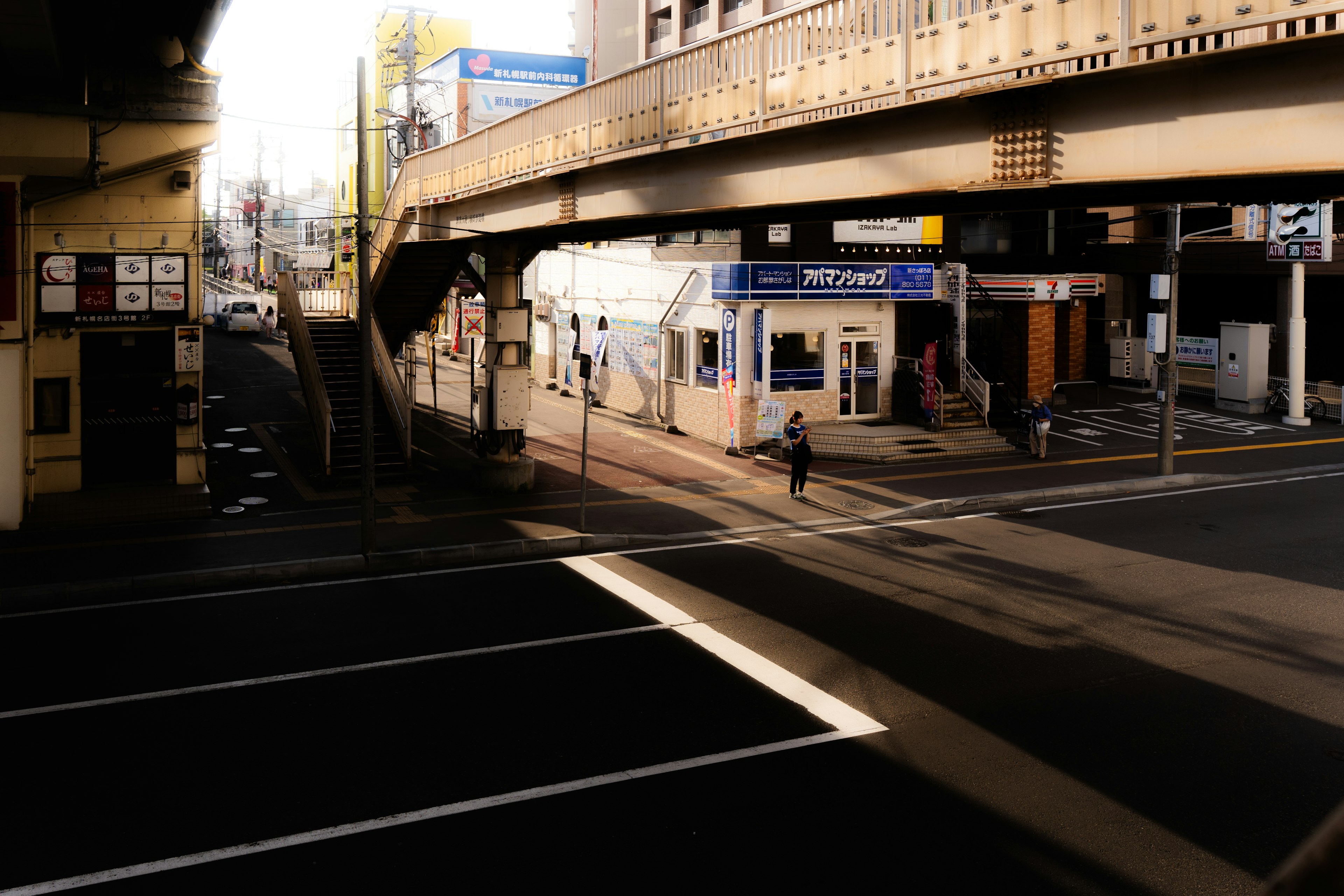 Urban intersection with an overpass and storefronts