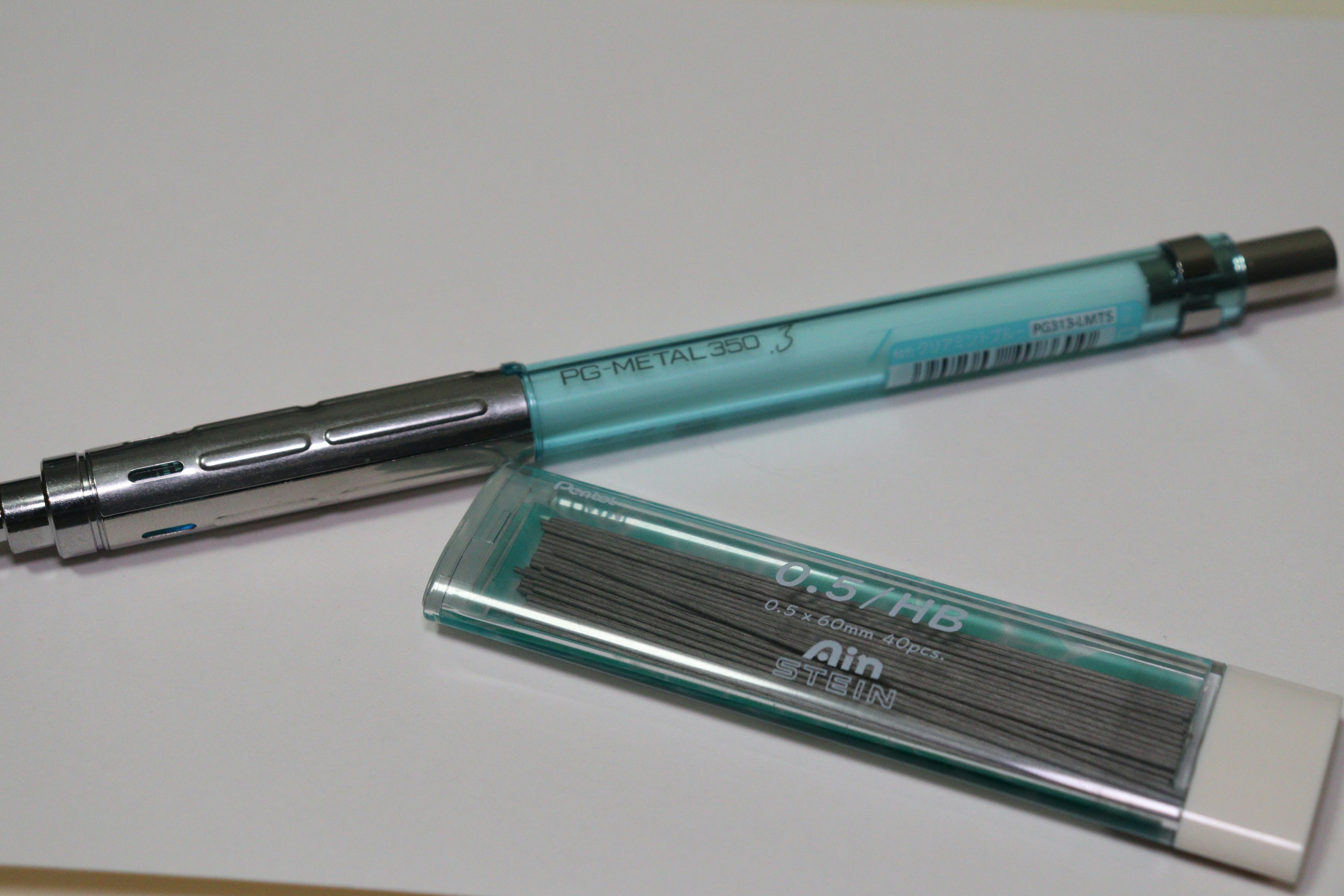 A blue body ballpoint pen and a transparent case containing refill cartridges