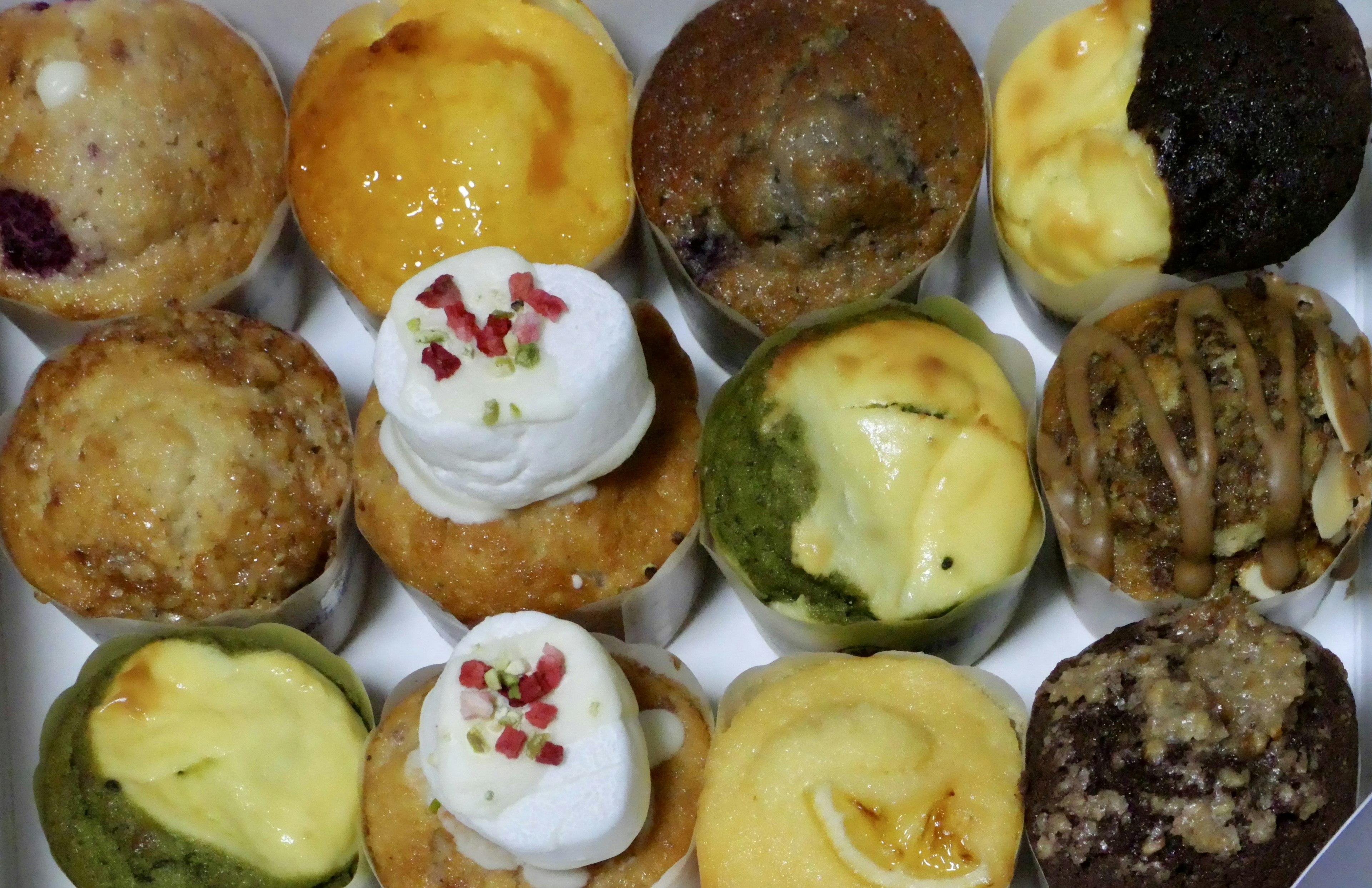 Colorful assortment of muffins arranged in a box